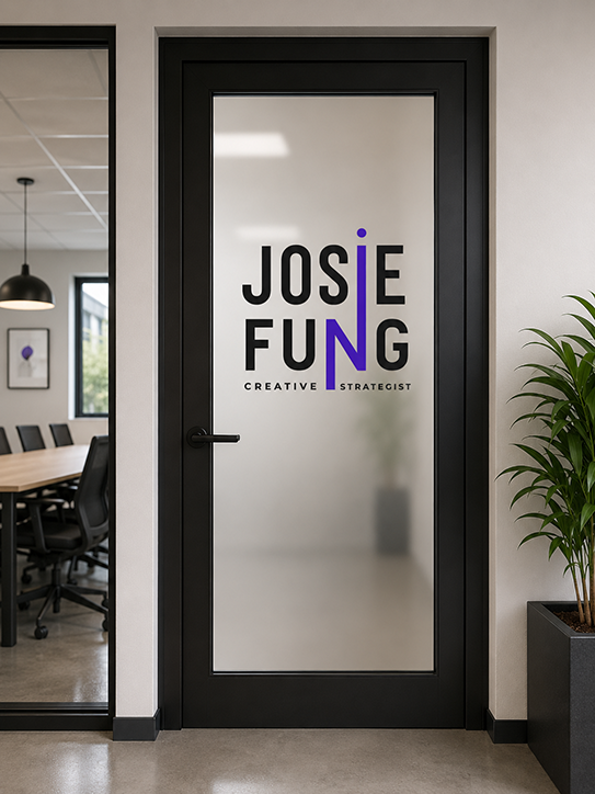 Office door with the logo and name 'Josie Fung, Creative Strategist' on the glass pane, with a conference room and office space visible inside.