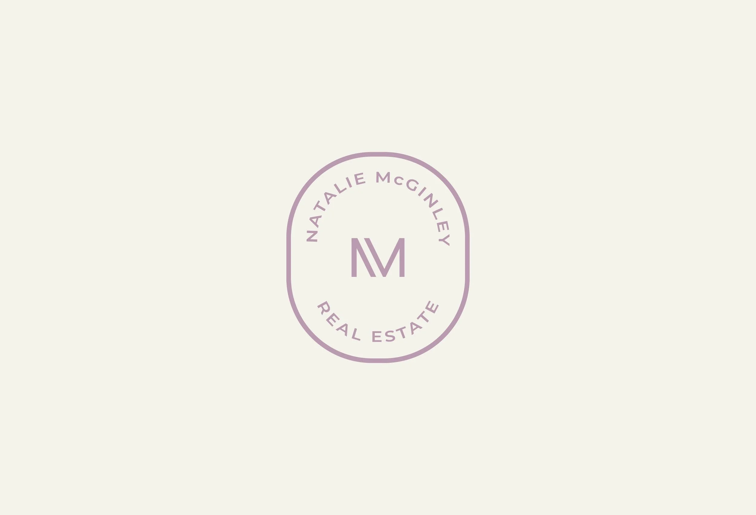Logo featuring the initials 'NM' with the text 'Natalie McGinley Real Estate' around it.