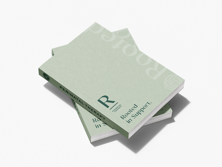 Stack of green booklets labeled 'Perinatal Therapy' with 'Received in Support' printed on the cover.