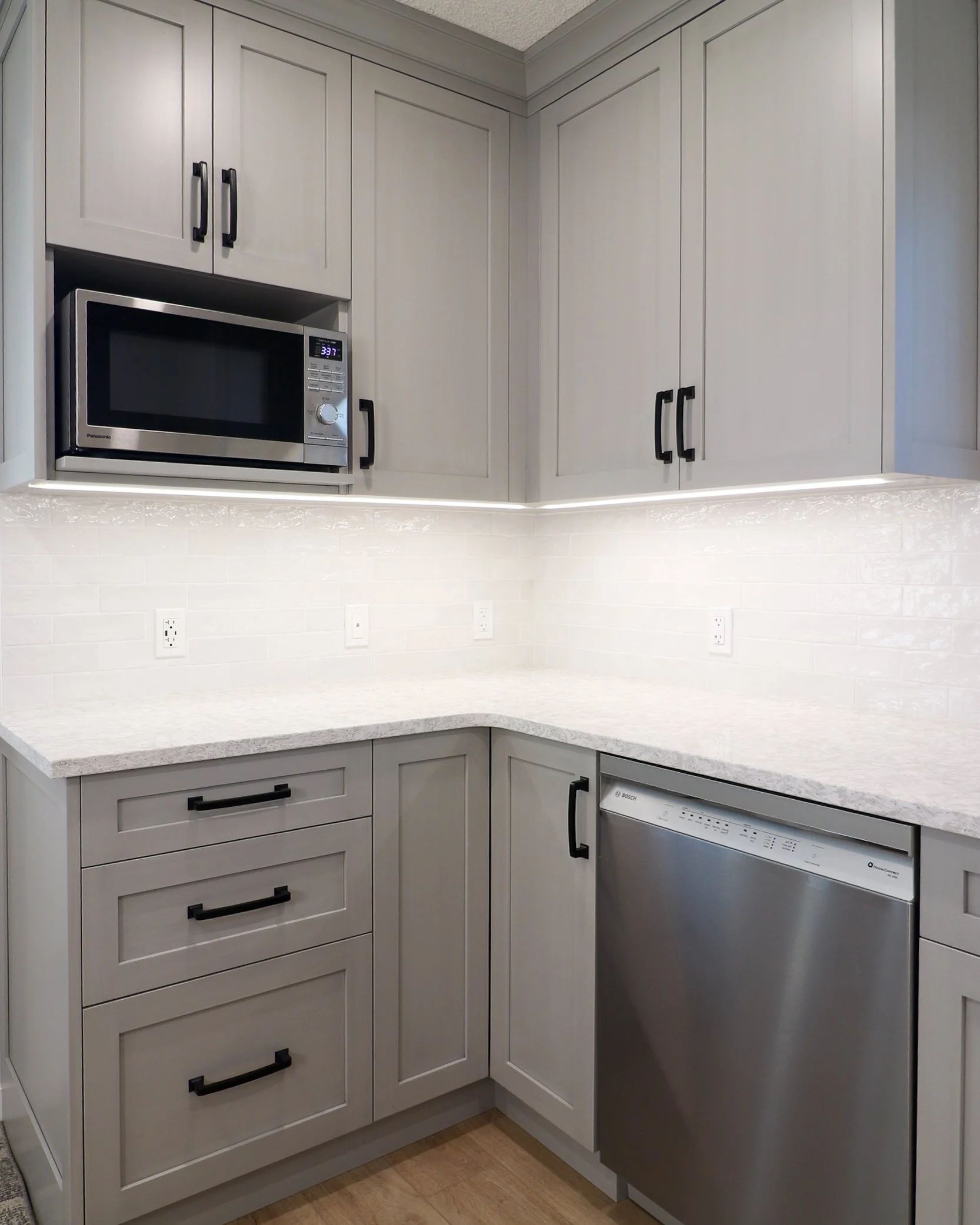 Stone Grey Shaker kitchen corner with microwave niche and dishwasher.