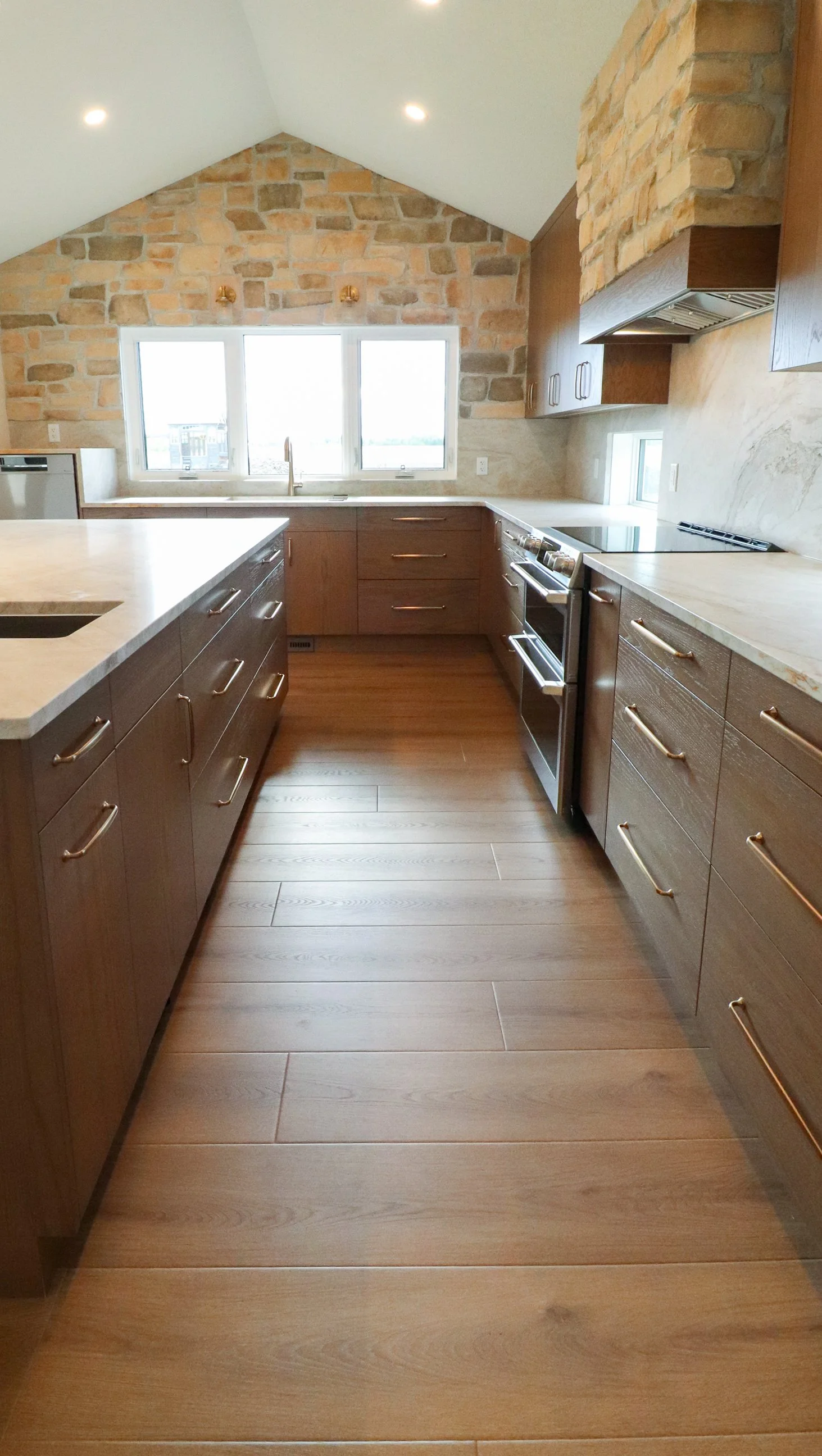 Galley view toward oak island and vaulted natural stone wall.