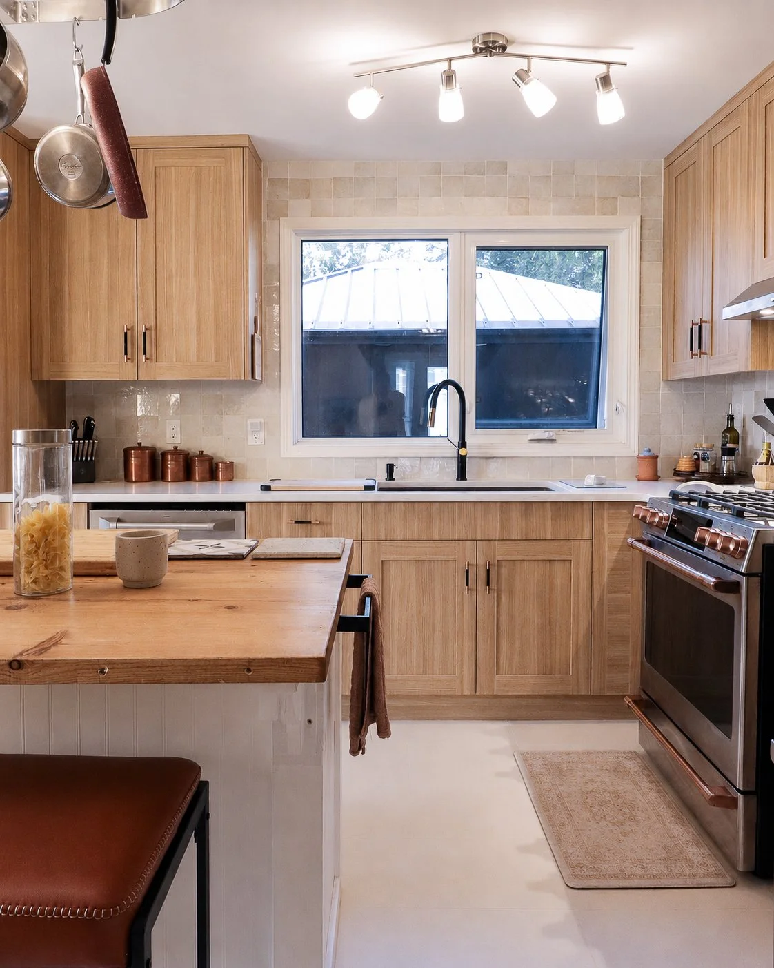 Window-centred black sink with Parona Walnut-finish cabinetry and range at right.