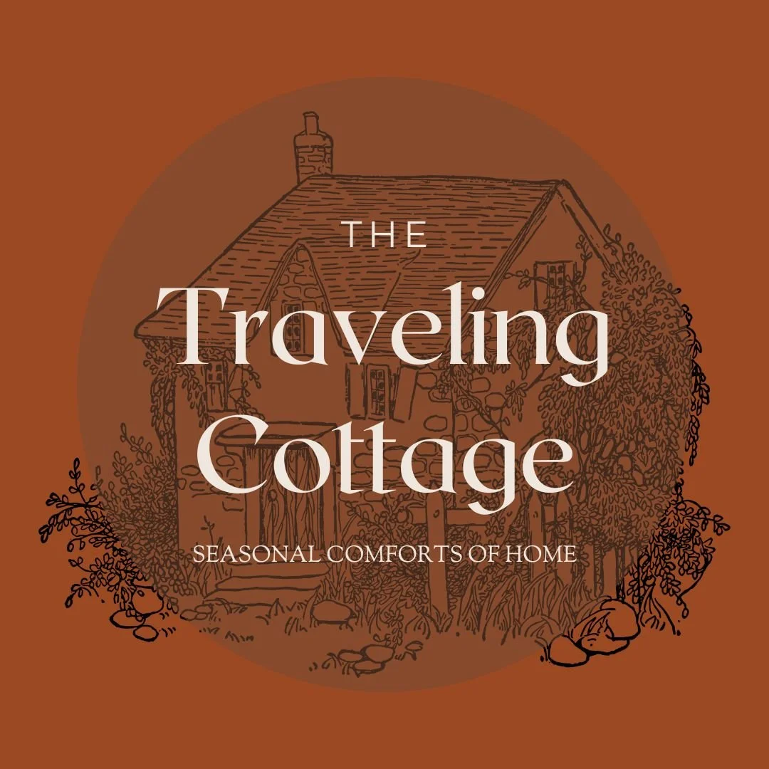 Logo reading "The Traveling Cottage, Seasonal Comforts of Home" overlaying a line drawing of a plant-covered cottage.
