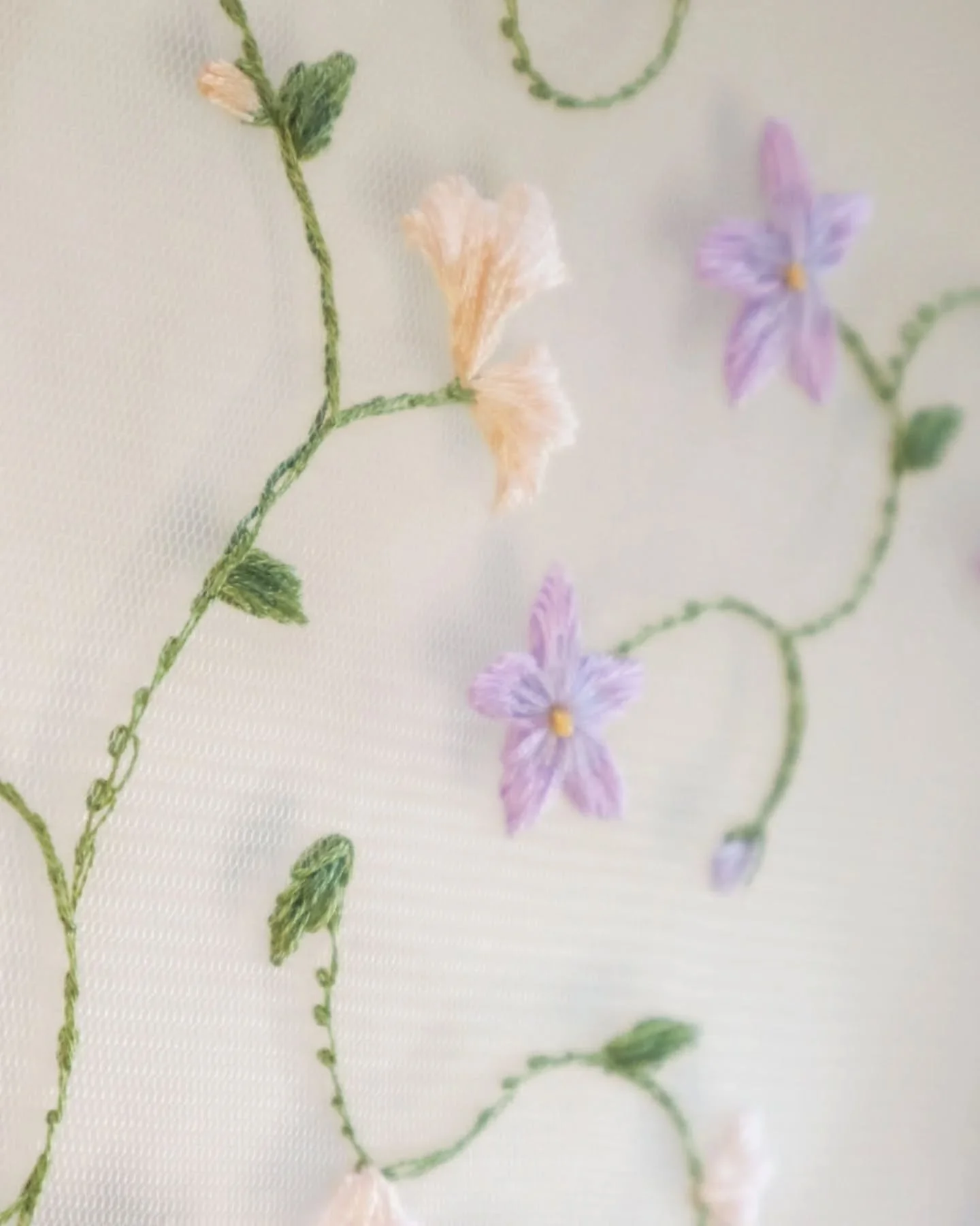 I've been working on this design in between bespoke pieces for months 🤍 I wanted it to be like hand embroidered lace with curlicues and blossoms, so that when the veil is worn it mimics a floral vine over your hair.

The colour palette is quite rest