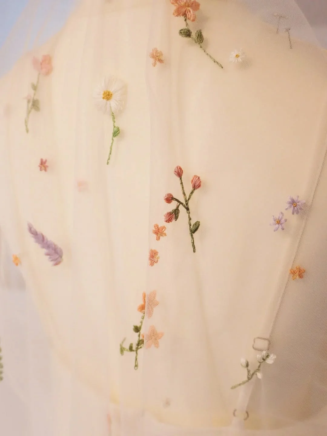 Delicate details for a bespoke veil in our signature Falling Flowers style 🤍

Embroidered by hand in shades of peach, lavender, ivory, and pale pink.

.

| mid length veils | floral veils | embroidered veils | garden weddings | #embroidery #handembr