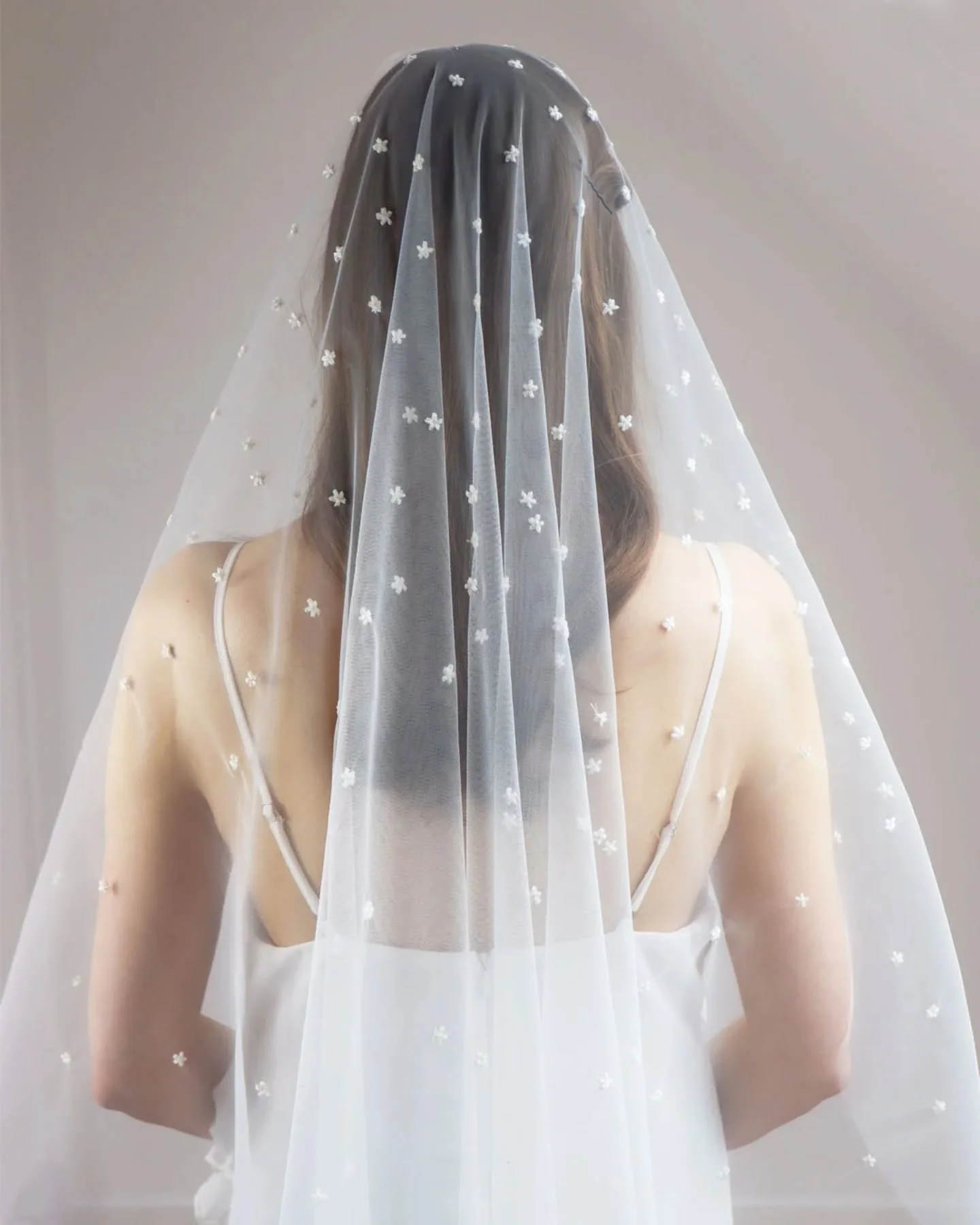 Introducing the Blossom Wedding Veil 🤍

Created in our signature Falling Flower style, this veil is hand embroidered with dainty little off-white blossoms, each one finished with a pale yellow French knot centre.

Drop veils and veils with minimal g