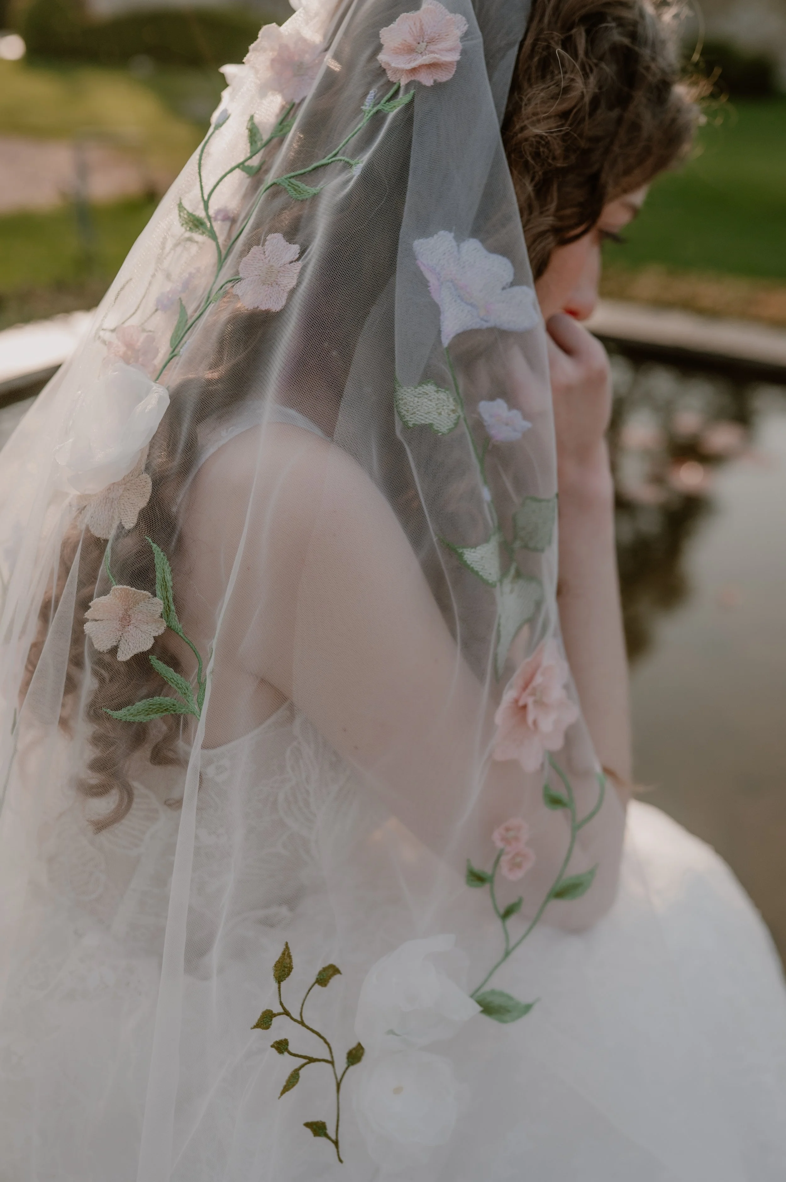 a close up of an embroidered veil with pale pink and lilac colours for a luxury wedding