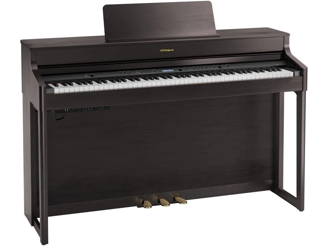 Black digital upright piano with a music stand, keyboard, and pedals.