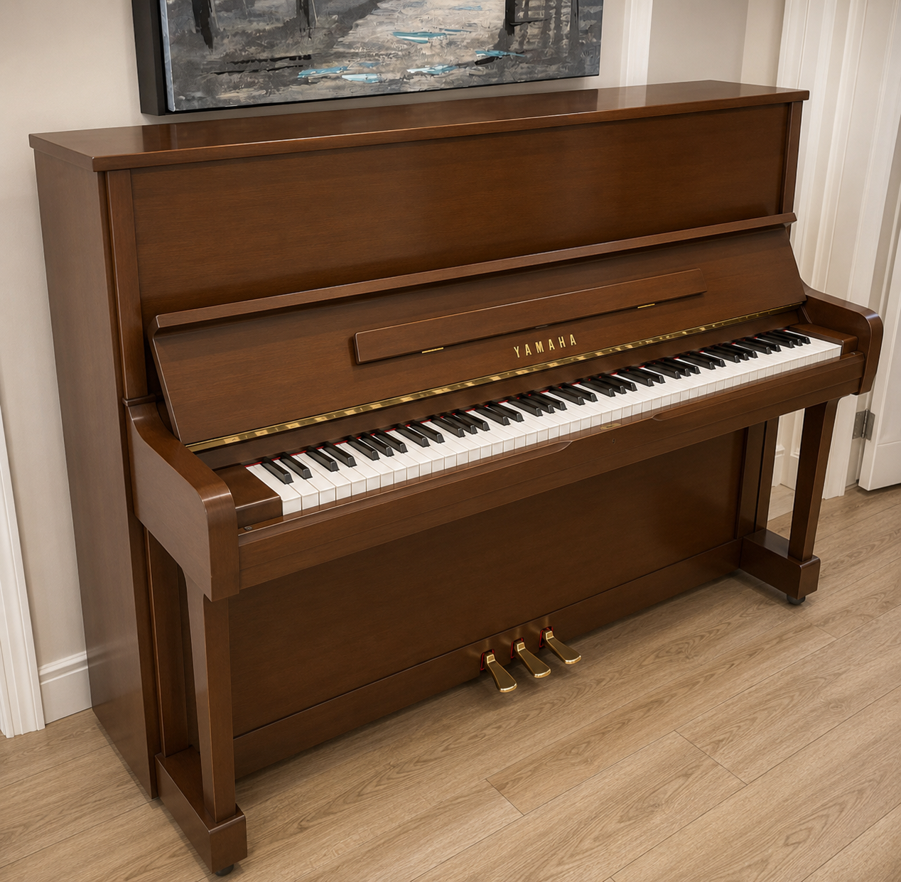 A wood finish Yamaha piano with gold pedals in a room with wooden floors and dark wood furniture.