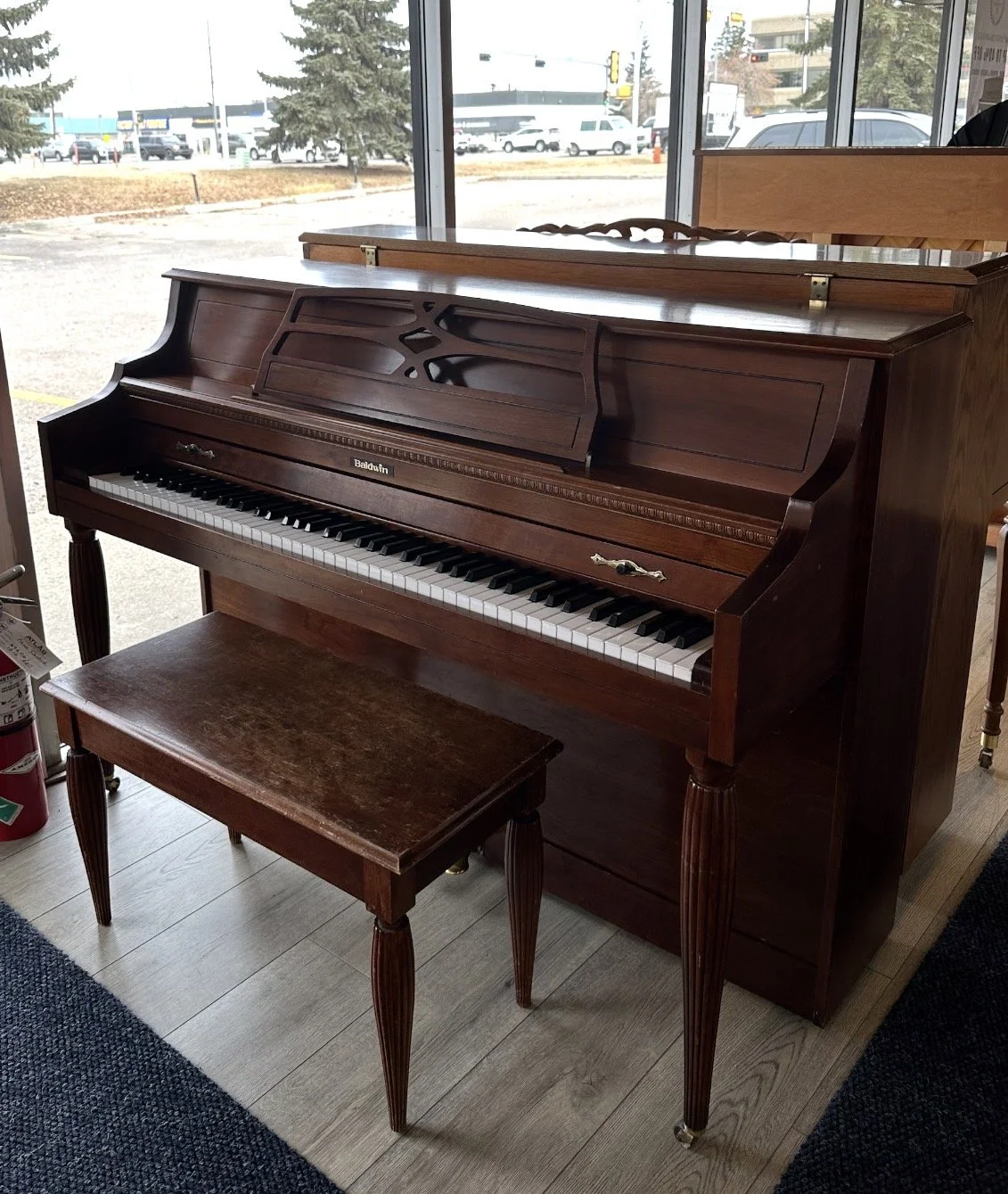 Baldwin Console piano in Mahogany finish - this handbuilt, all solid wood piano has a wonderful, classic Baldwin tone and has a nice light action. A great starter instrument for any beginner, young or mature! only $1,799!