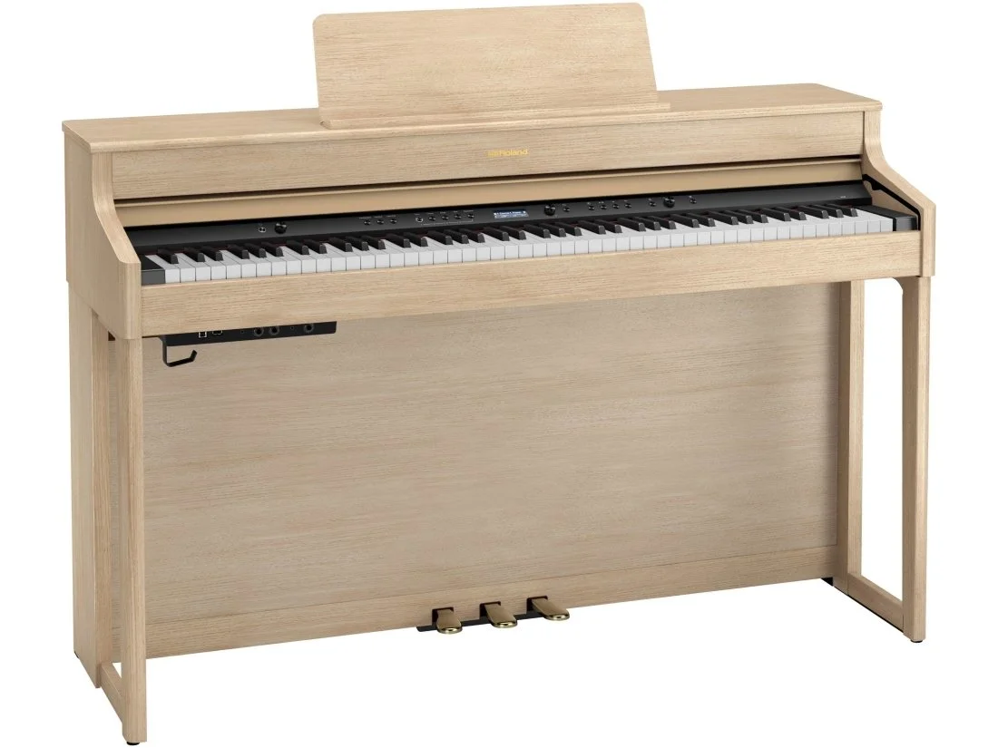 Light wood digital upright piano with 88 keys and three pedals at the base.