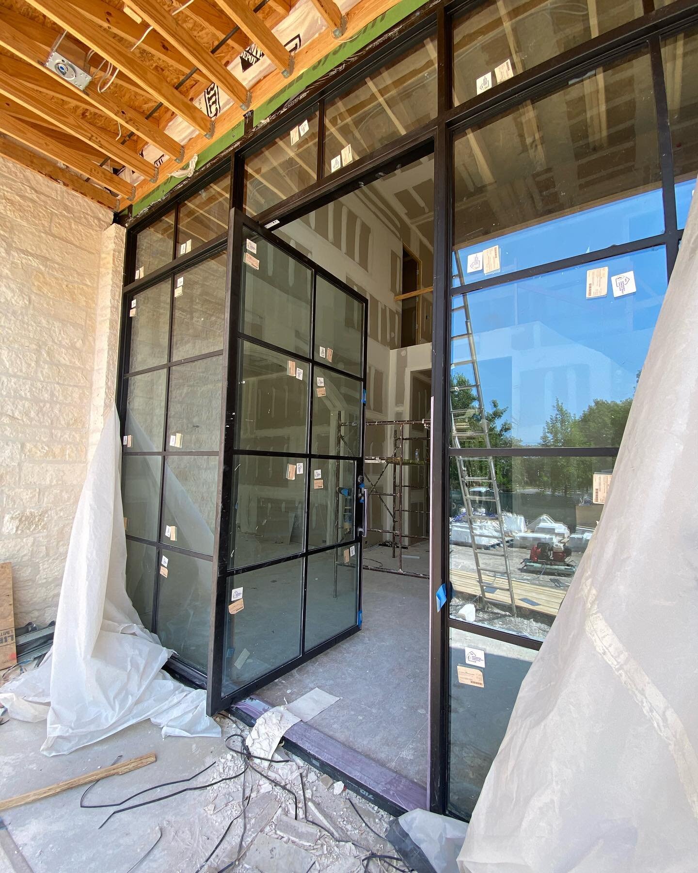 Could not wait for the house to be finished to show you this massive 12&rsquo; tall pivot door within a glass wall 🥹 The window in the second story adds some character 👏🏽 Notice that protected threshold 👀 we cater to builder needs 🥰

#steeldoors