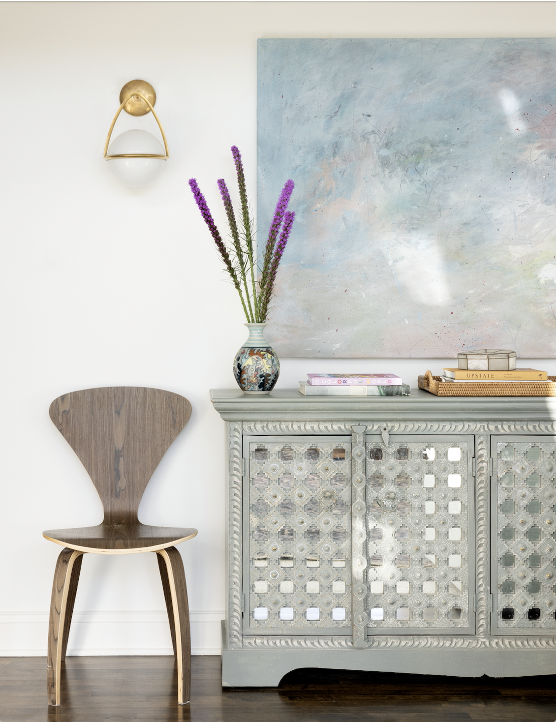 Blue mirrored credenza and globe sconce.png