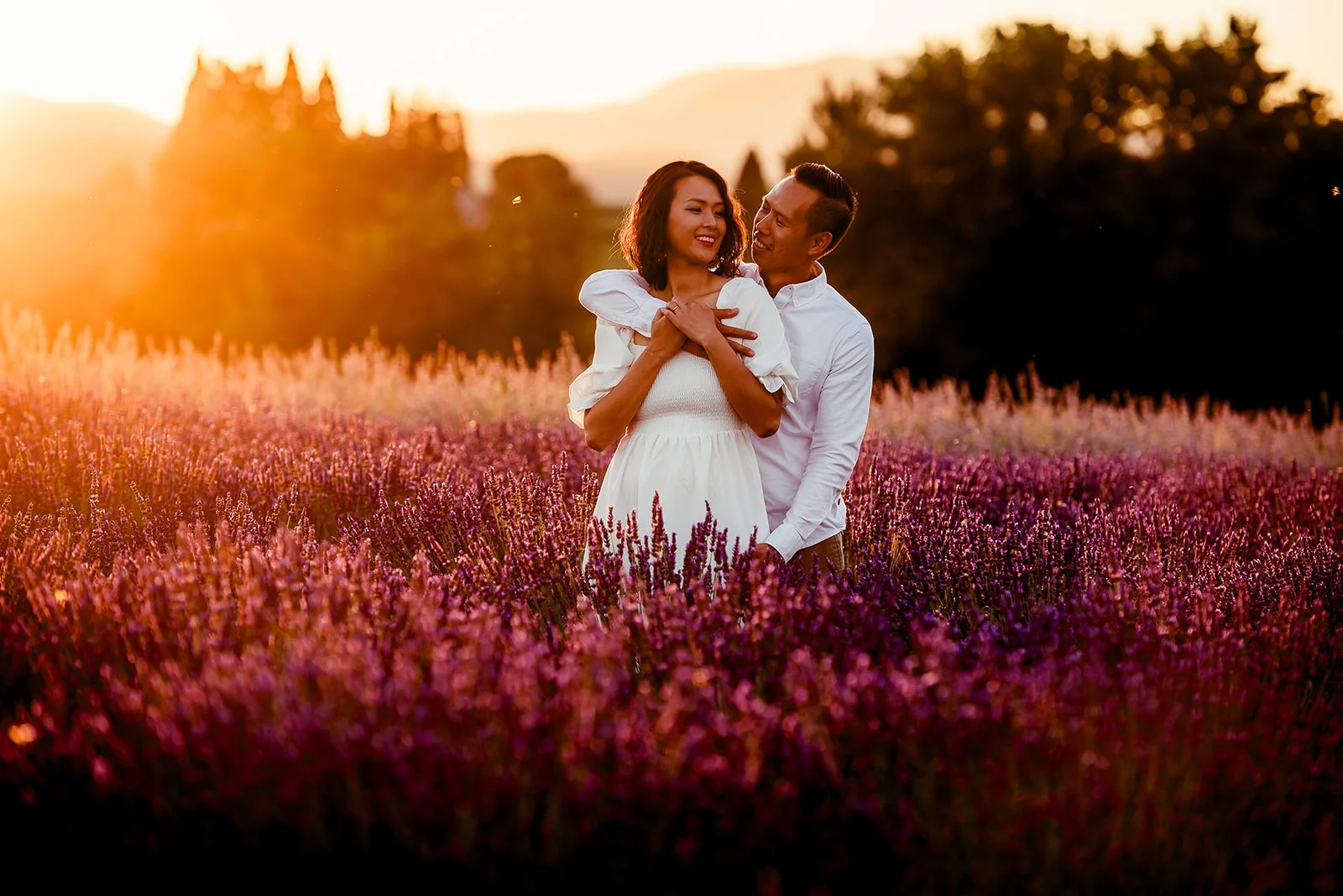 Wedding venue, events wedding photography, Hood River, Oregon, A couple standing in a lavender field at sunset, embracing and smiling Hope Ranch Lavender.