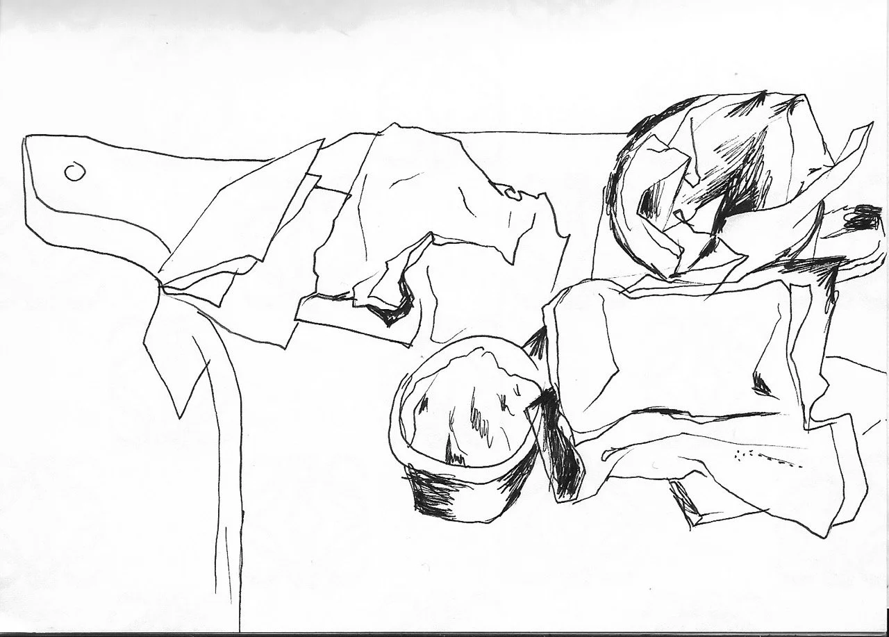 Black and white sketch of a table with a knife, a halved lemon, and crumpled paper or foil.