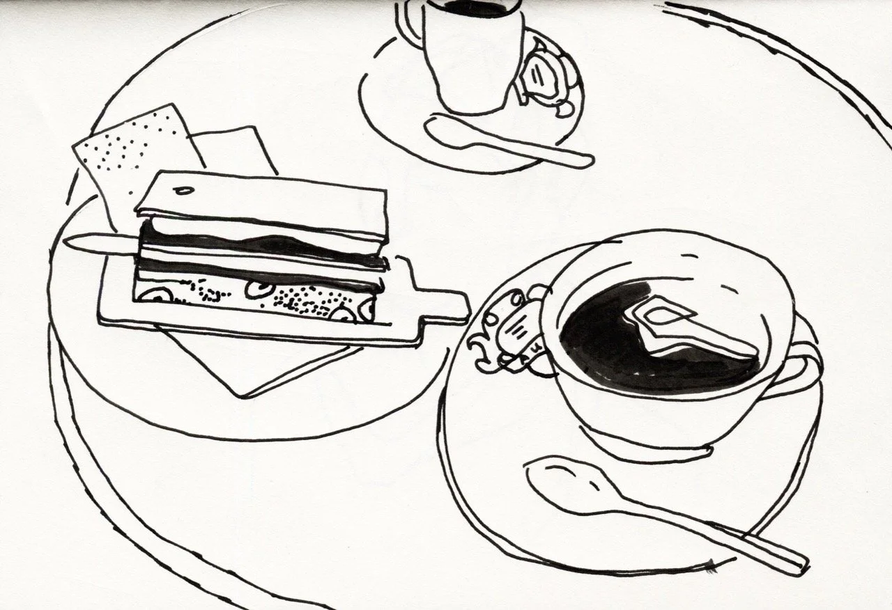 Line drawing of a table setup with a cup of coffee, a slice of layered cake on a plate, and a small spoon.