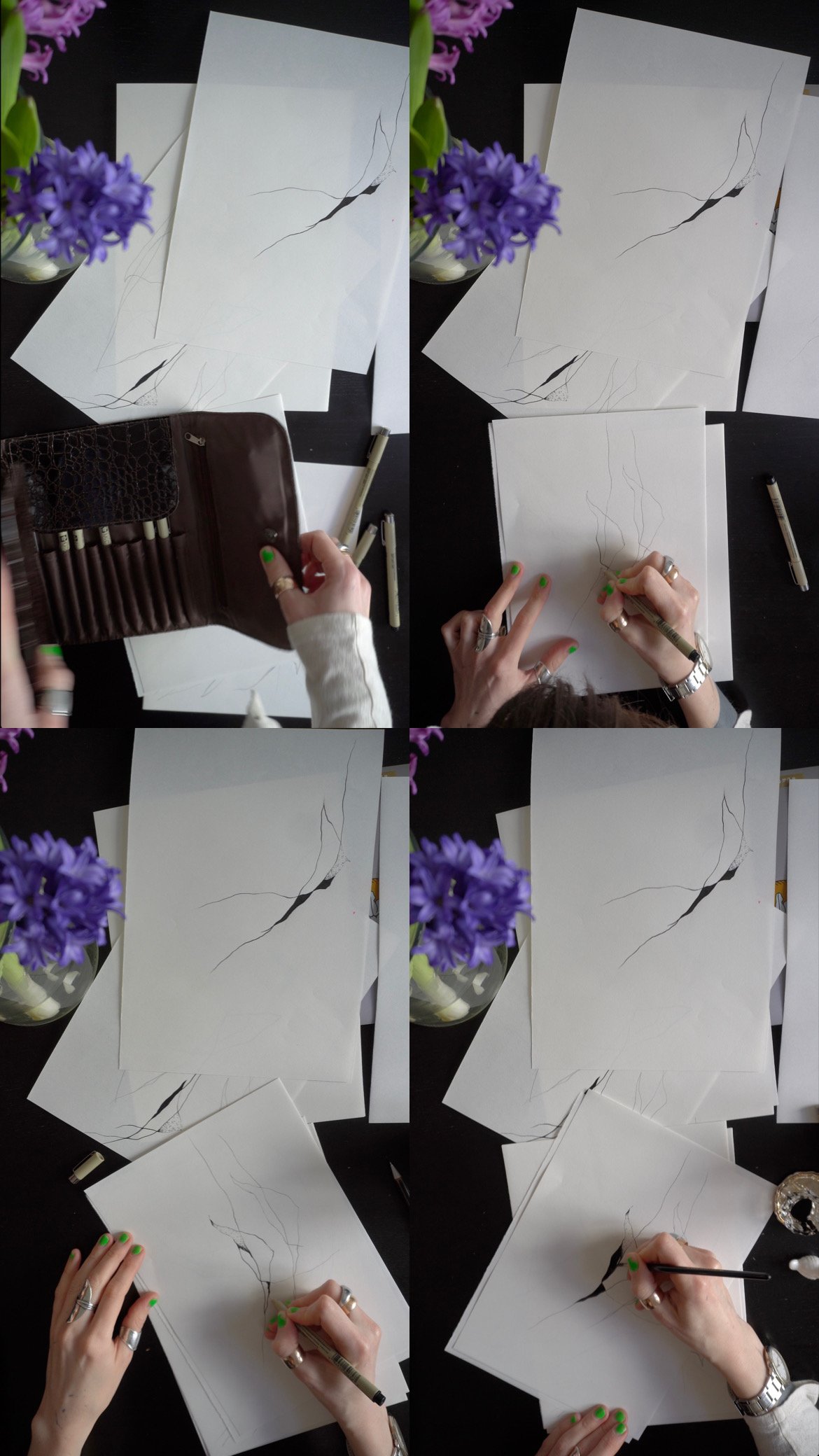 A person creating a line drawing of a crack on white paper with a black pen, surrounded by additional sheets of paper and markers, with purple flowers on the side.