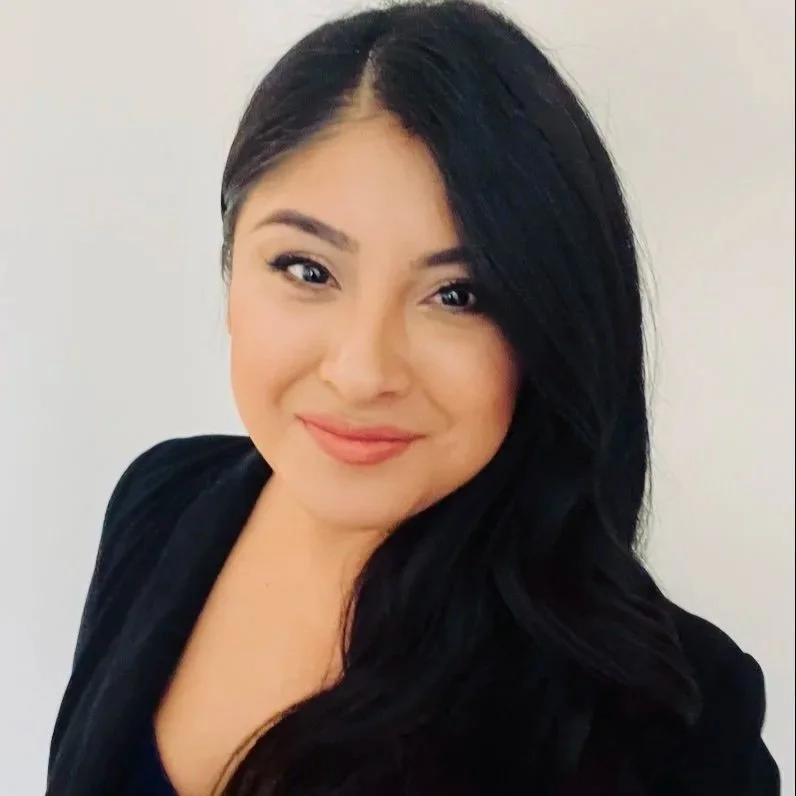 A smiling woman in a black blazer