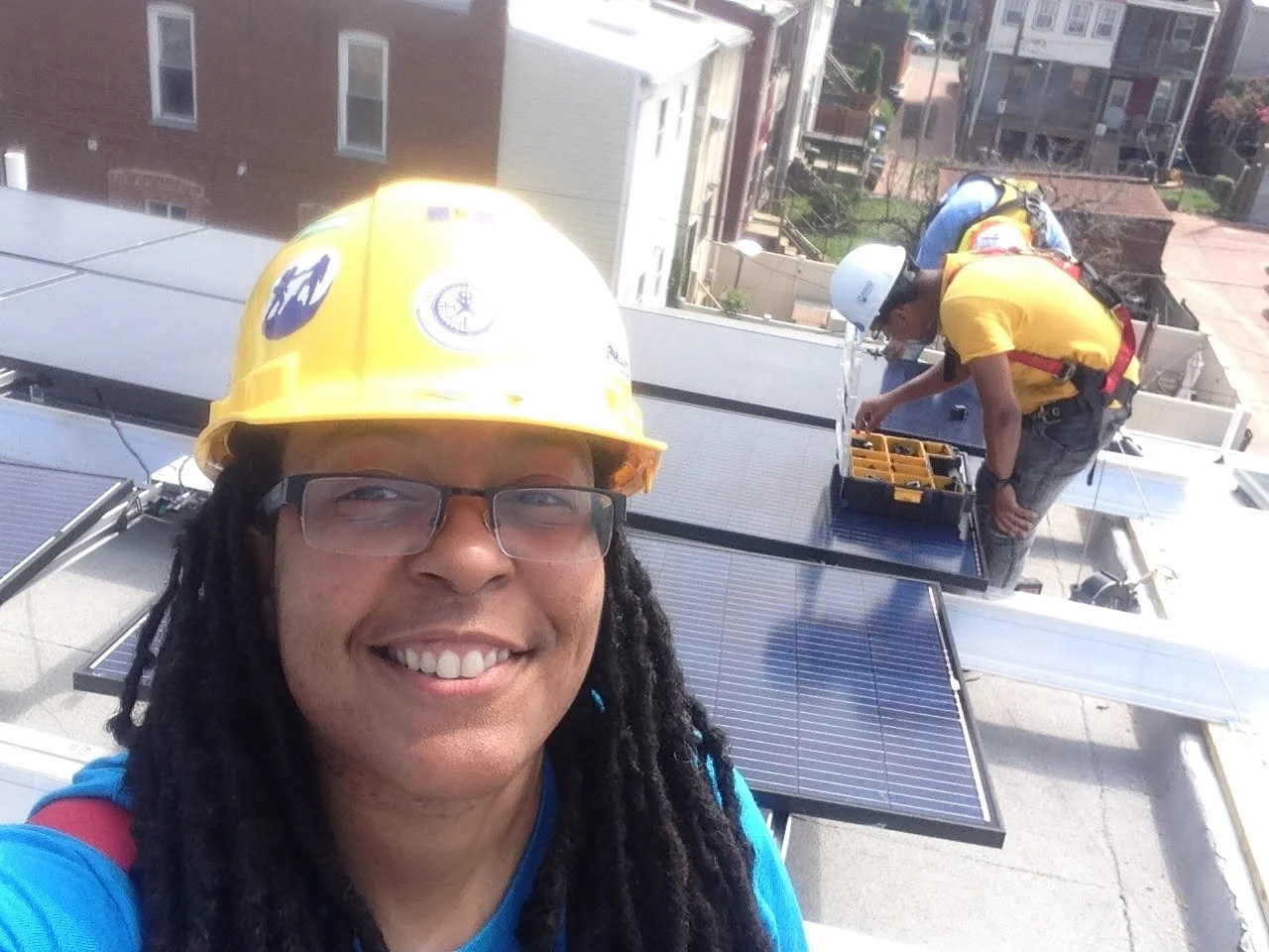 Erika Symmonds on a Rooftop Installing PV