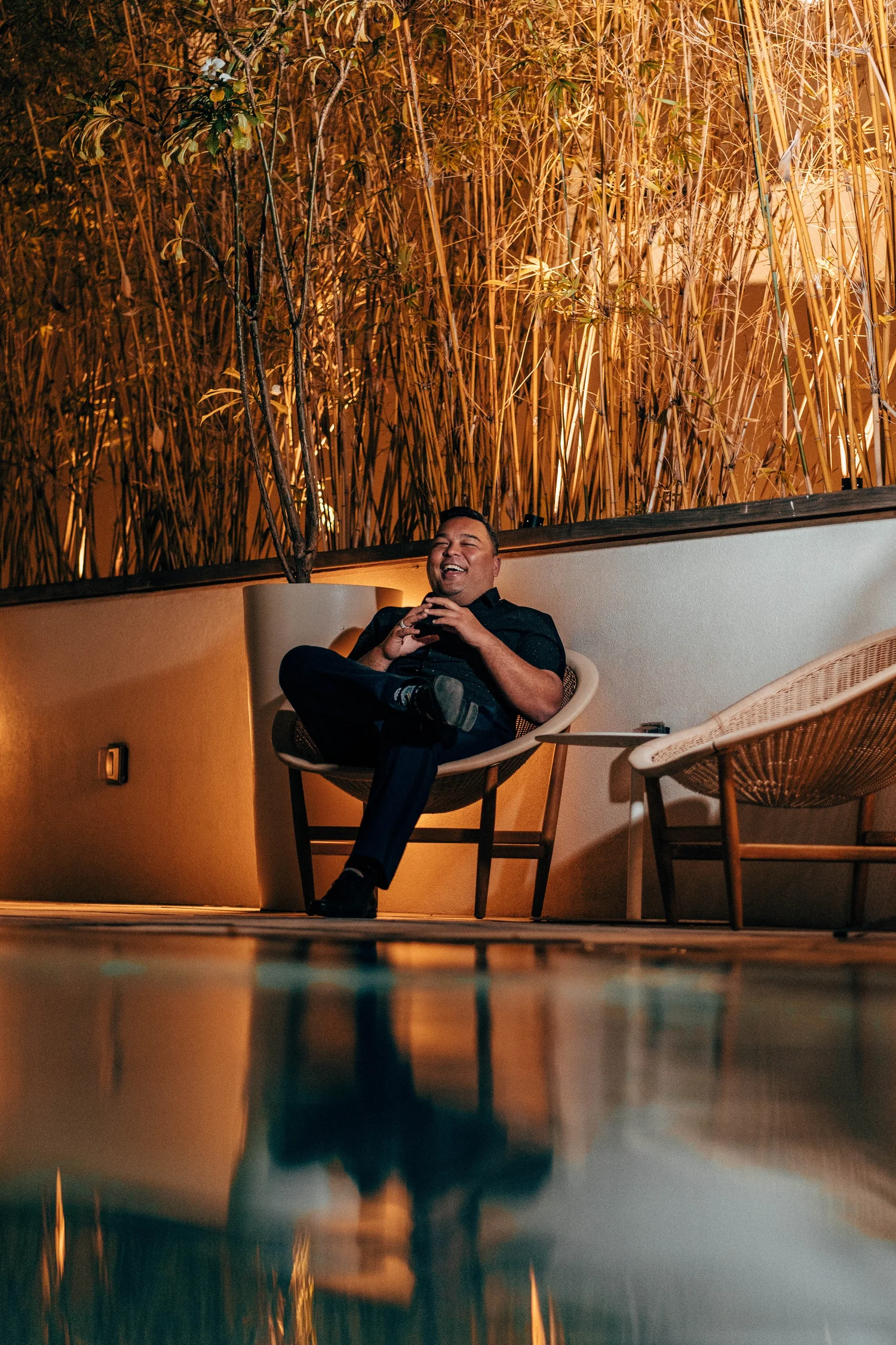 Man laughing in a modern outdoor lounge chair