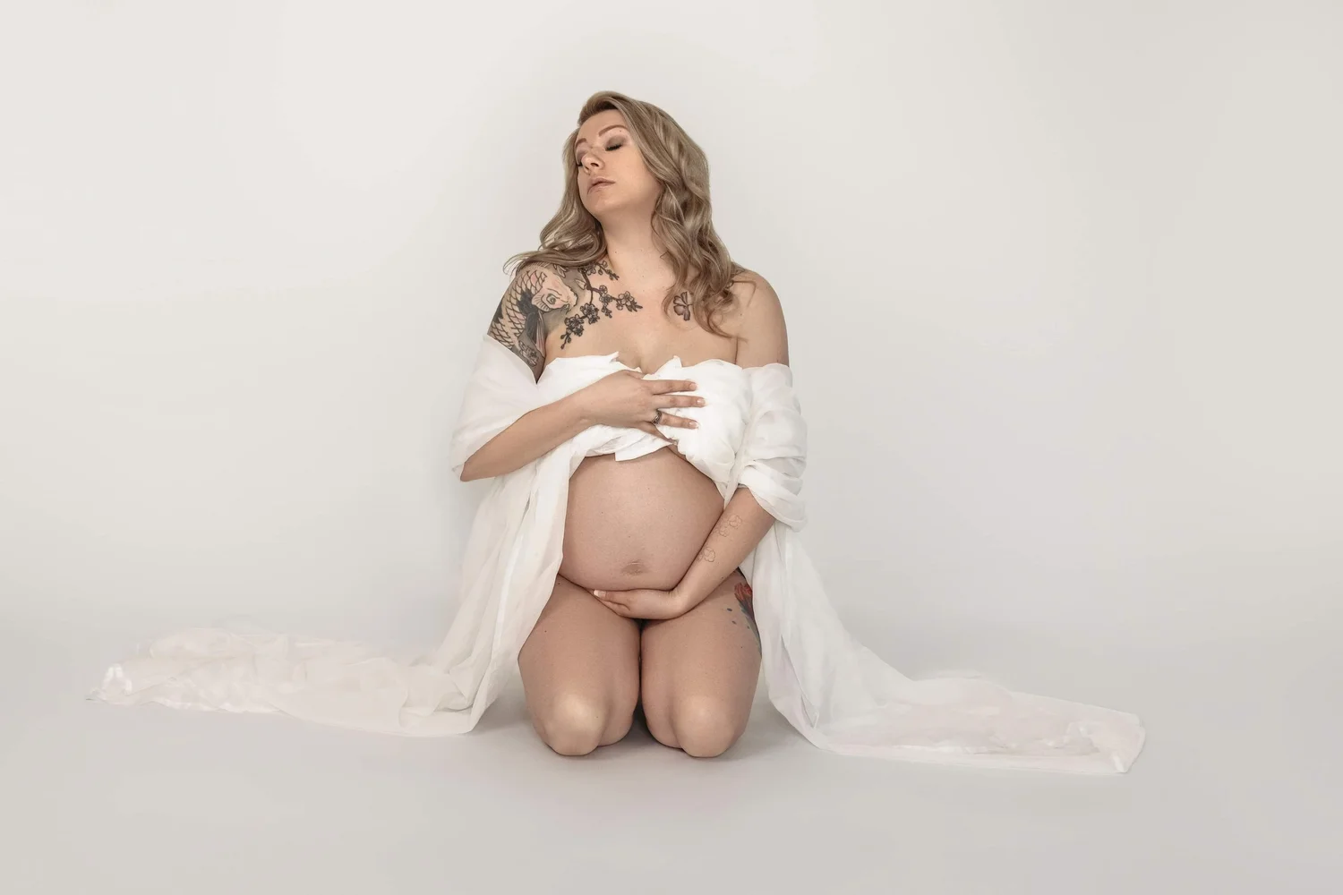Maternity boudoir photography in Salt Lake City, Utah — expecting mother photographed in soft light at Blushed Boudoir's private studio