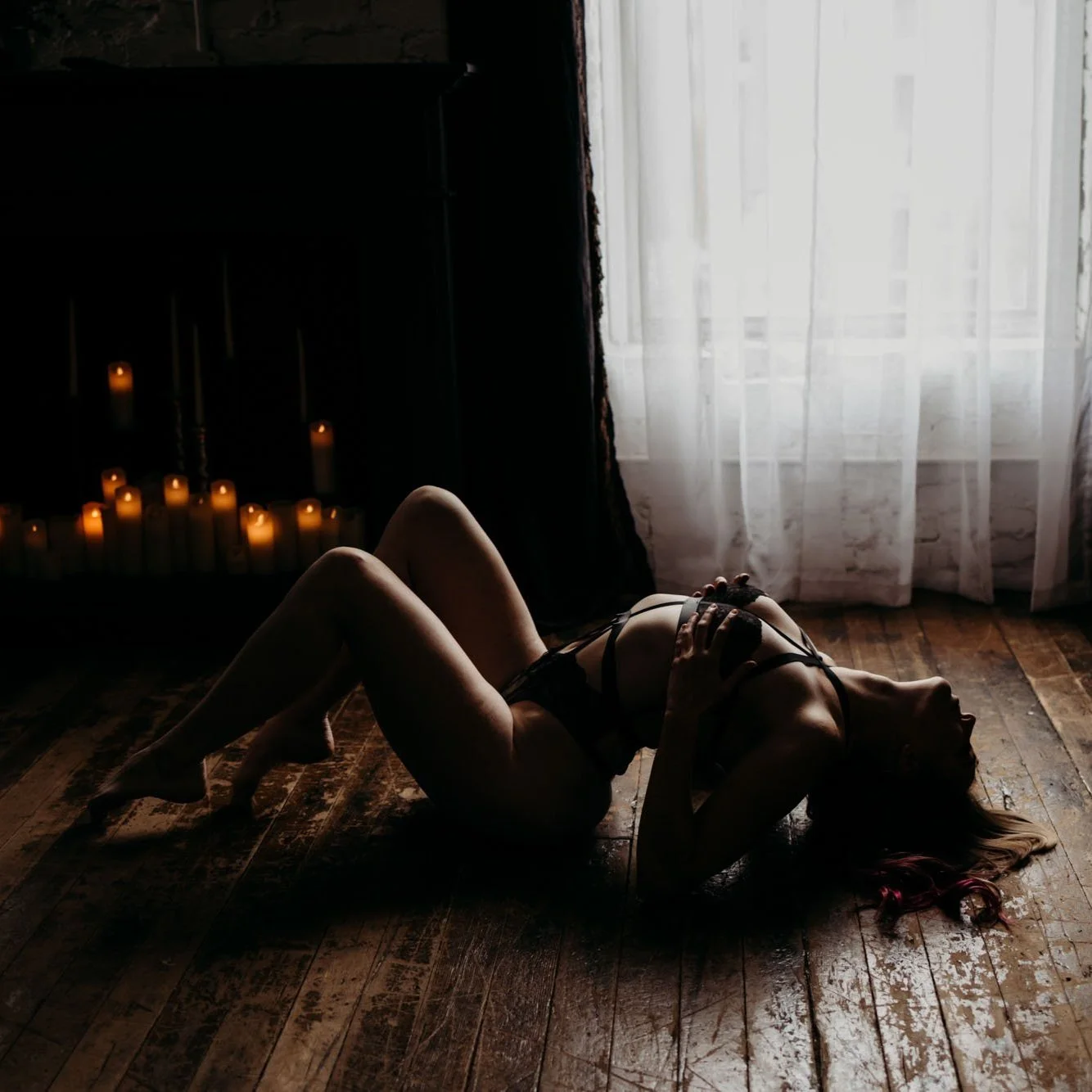 Low-key boudoir portrait shot in deep shadow at Blushed Boudoir, Salt Lake City