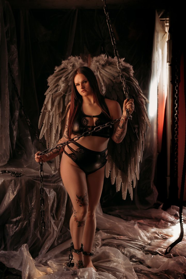 Dark fallen angel boudoir portrait with feathered wings at a private Utah studio
