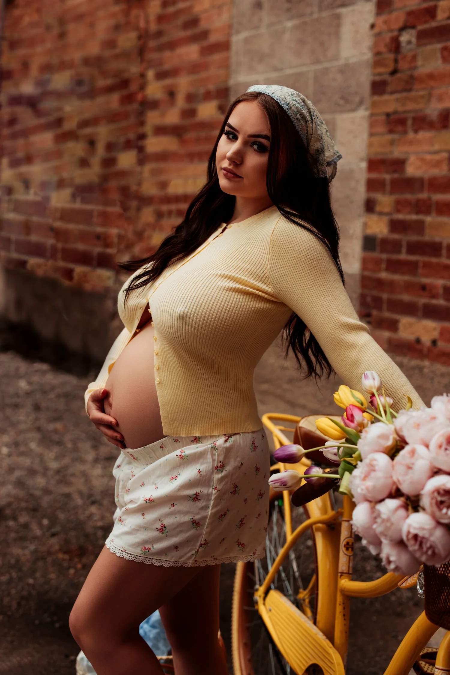 Expectant mother cradling her belly during an outdoor maternity boudoir session with Blushed Boudoir in Utah