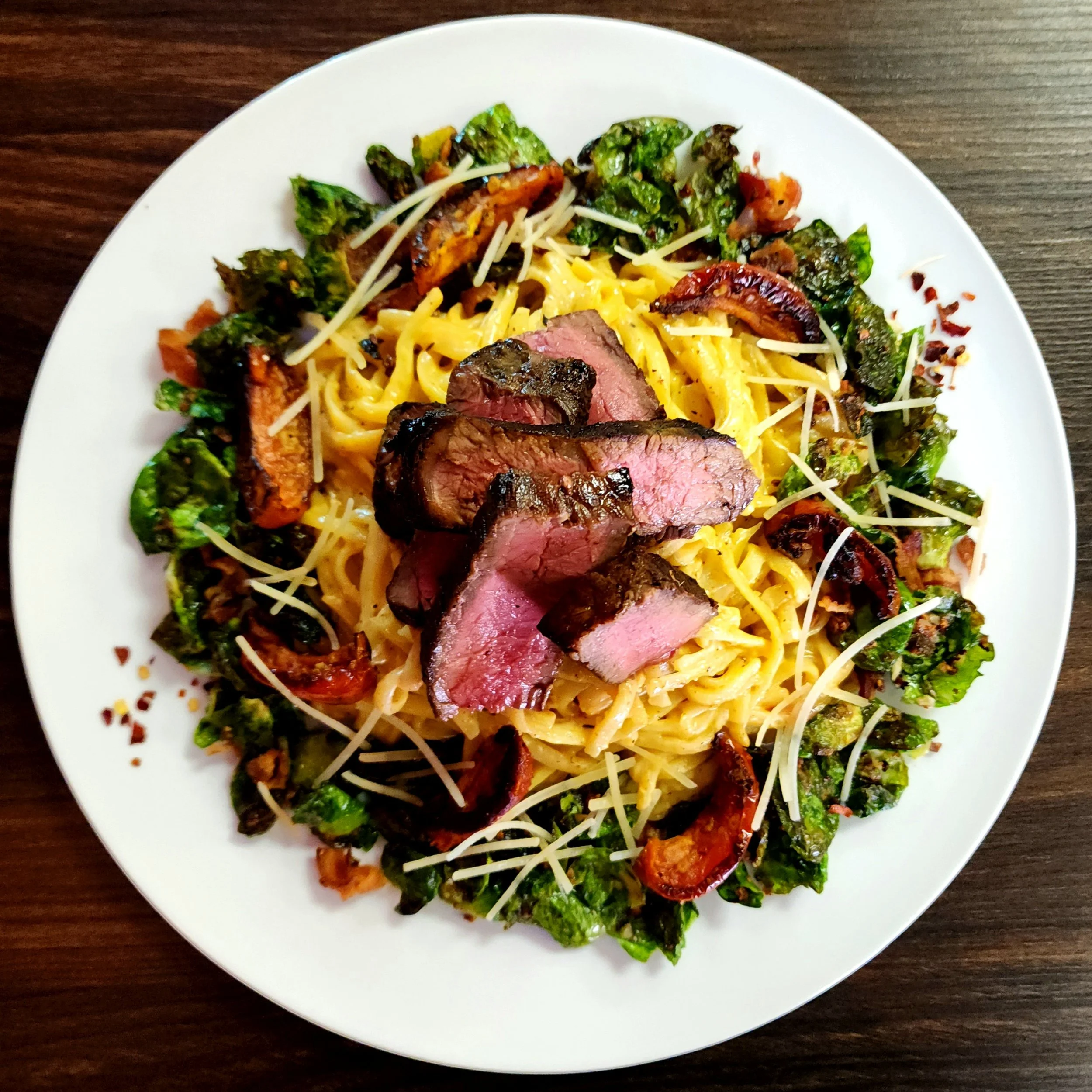 Gunpowder Steak Alfredo w/ Crispy Brussel Petals & Fire Roasted Tomatoes.