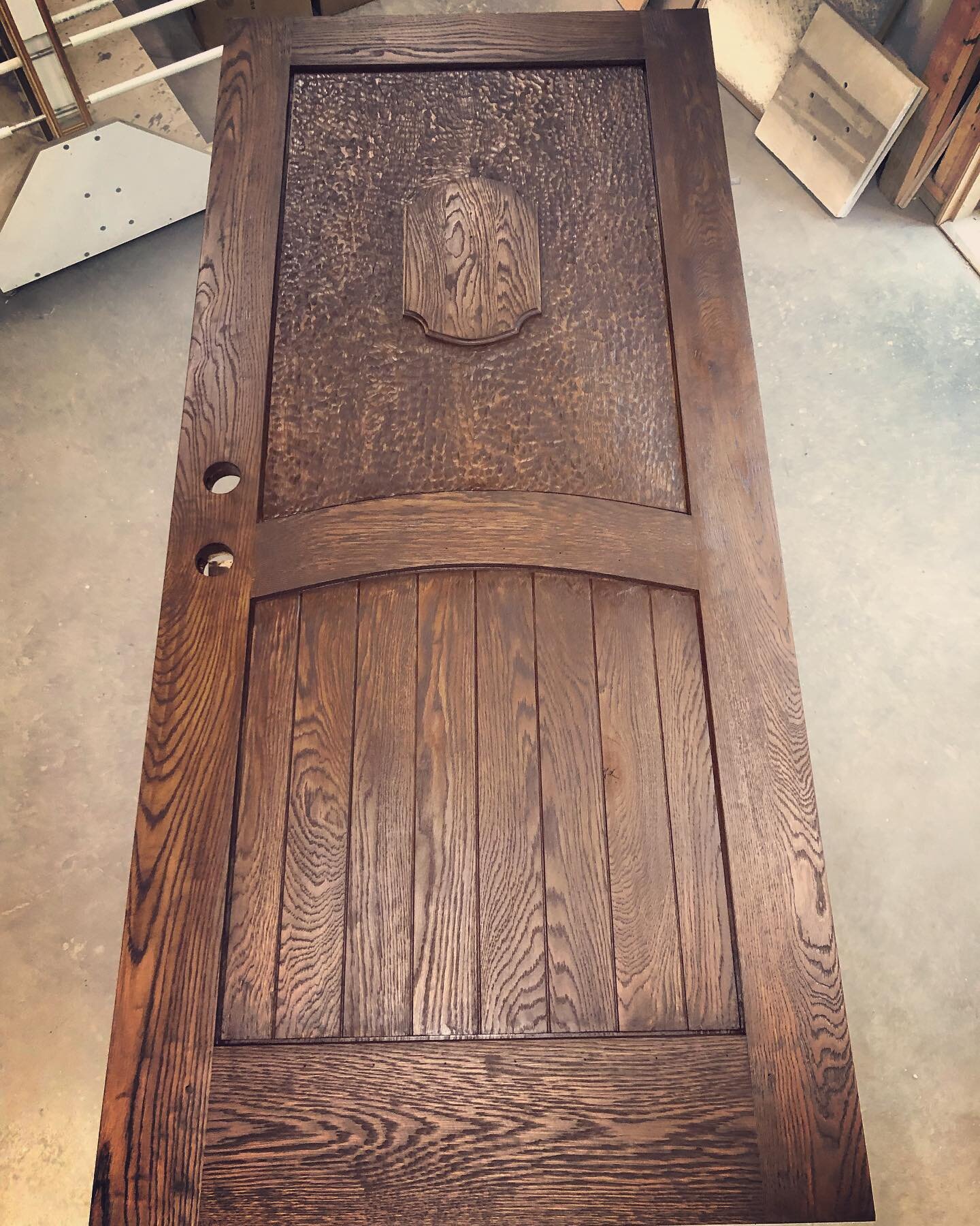 Custom oak front door with wire brushed finish and hand gouged details.