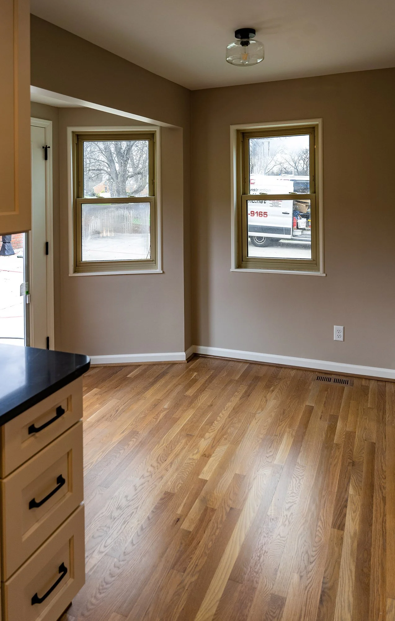 Complete First Floor Remodel by KBC Inc. Detail shot of open living space, with exterior window view.