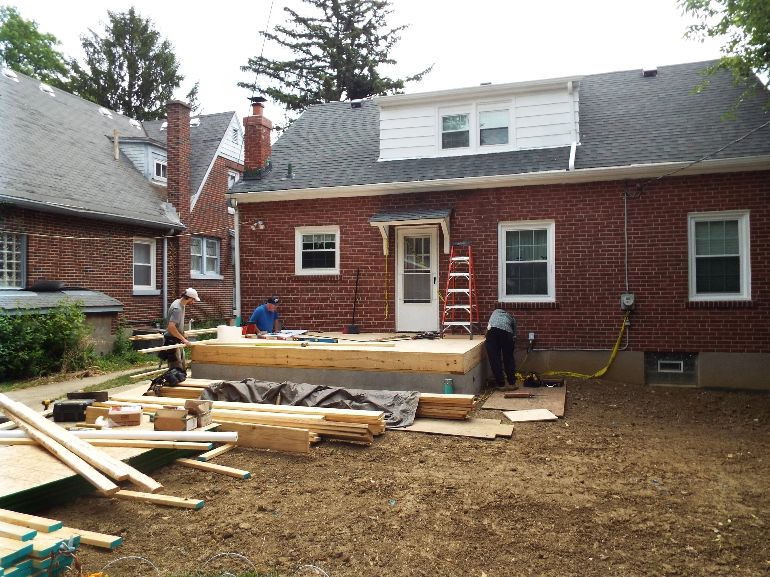 Outdoor view of  workman beginning framing