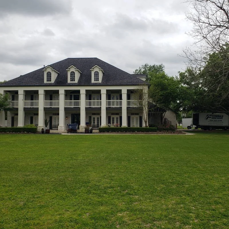 Fitzgerald Moving Services truck at a columned Southern estate