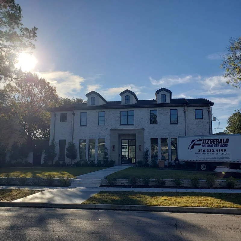 Fitzgerald Moving Services truck at a white brick Houston estate