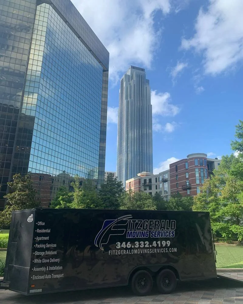 Fitzgerald Moving Services trailer on a commercial job near the Houston skyline