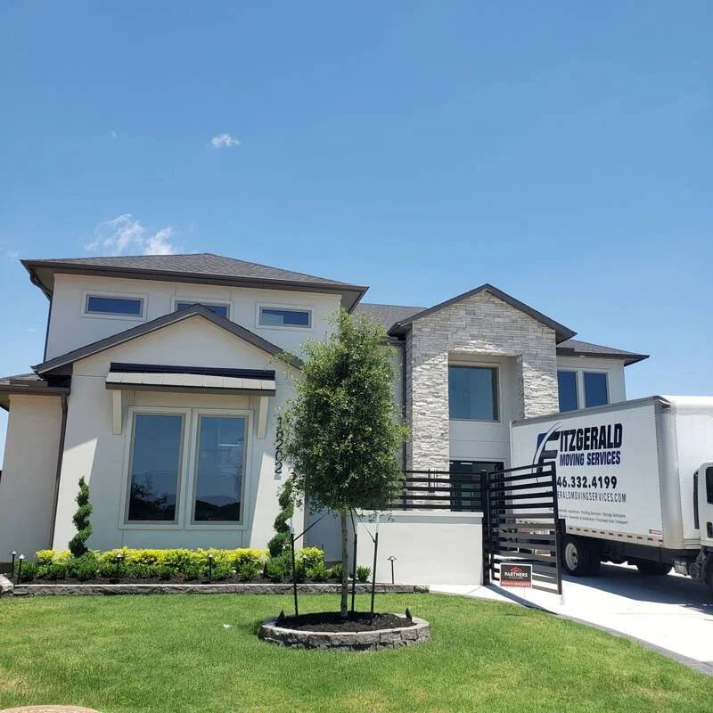 Fitzgerald Moving Services truck at a new-construction Houston home