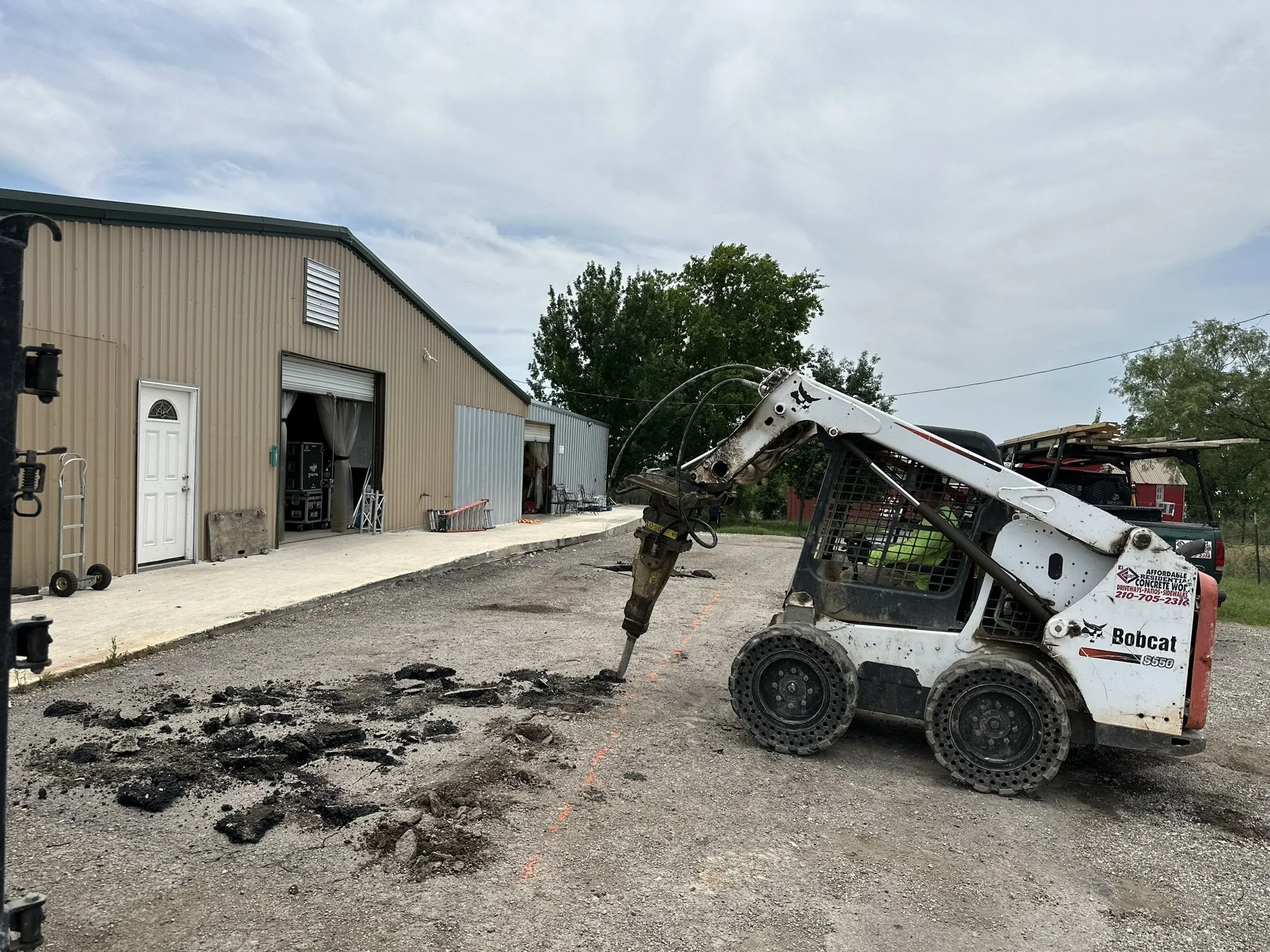 Concrete driveway demolition and removal in San Antonio, TX. Affordable Concrete & Construction removing the existing concrete and preparing the site for a new reinforced concrete driveway installation.