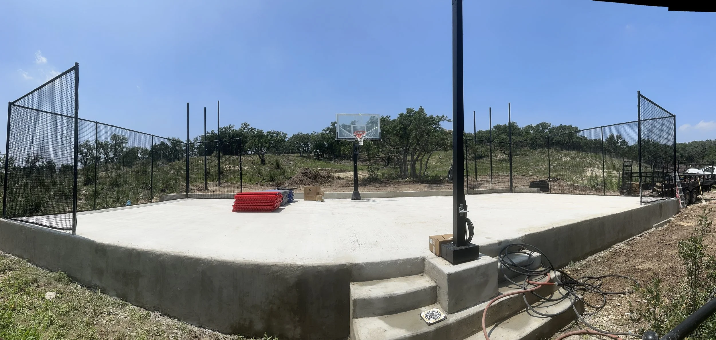 Completed pickleball court with fencing, lighting, and reinforced concrete slab in Boerne, TX