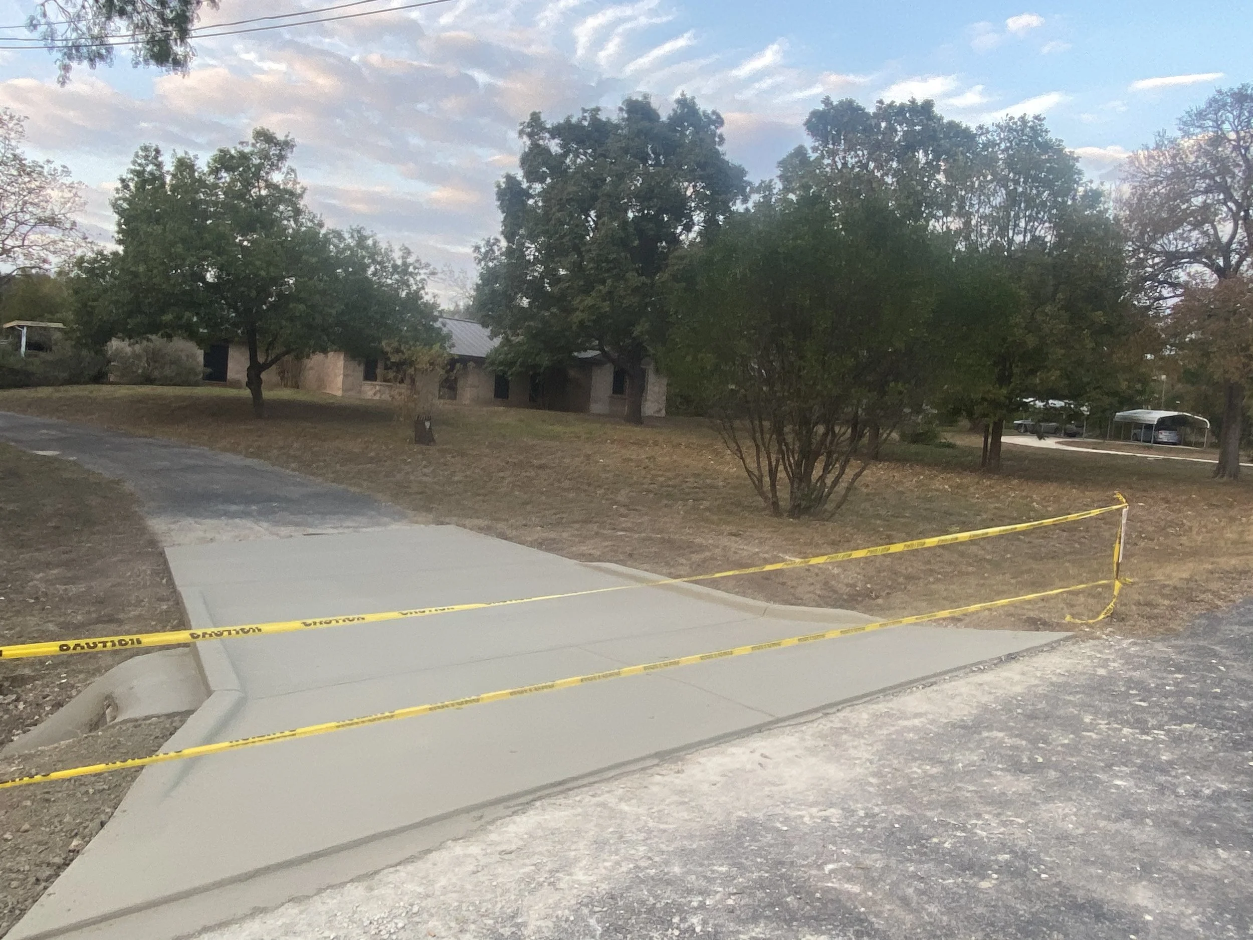 New concrete driveway approach and entrance in San Antonio, TX, constructed by Affordable Concrete & Construction to provide a durable transition from the roadway to the new driveway.