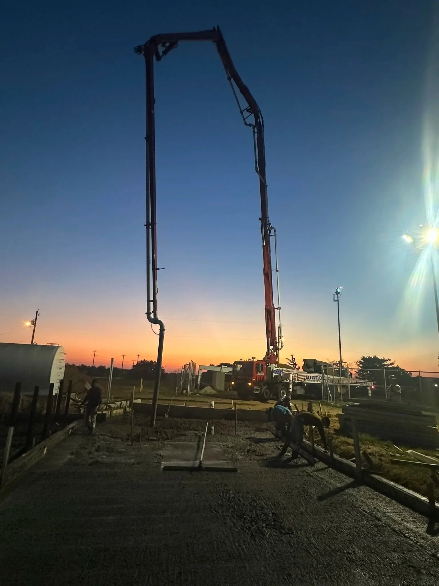 Concrete pump pouring foundation for pickleball court construction in Boerne TX