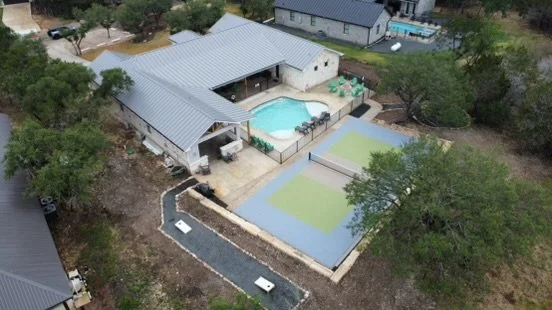 Custom backyard pickleball court with acrylic sports surface in Boerne, TX built by Affordable Concrete & Construction