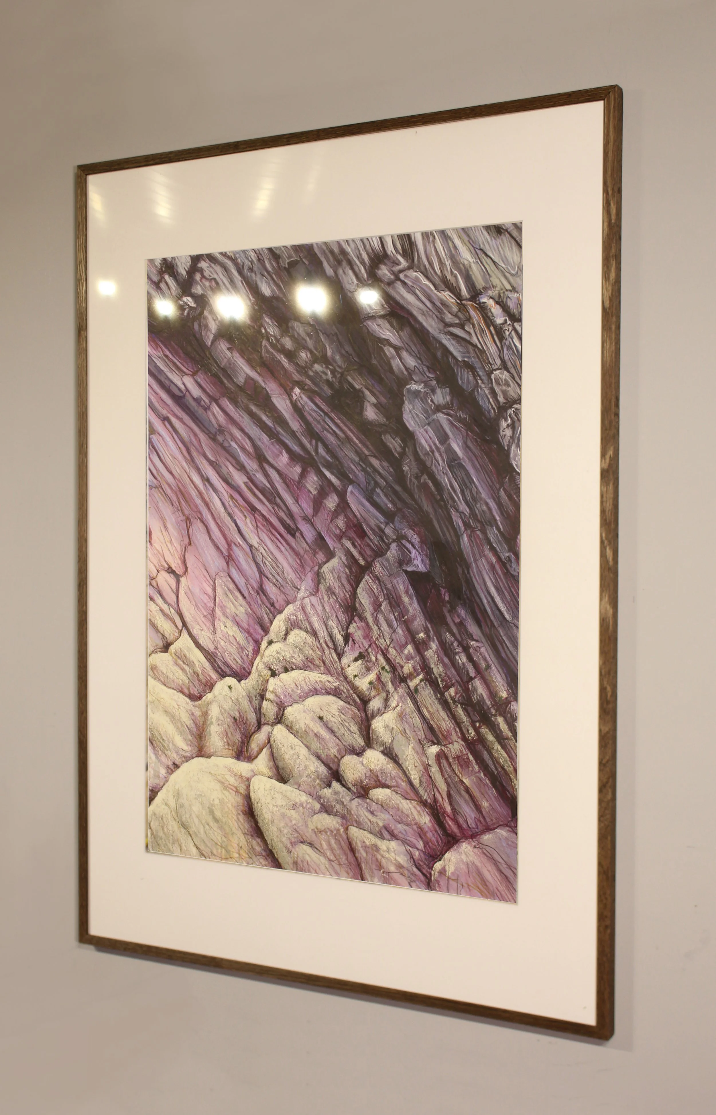 A close-up detail drawing of a rockface that has textured painted surface detail to portray the barnacles on the deep mauve rock strata that cracks diagonally across the picture. The flattened perspective creates an abstracted and dynamic effect.