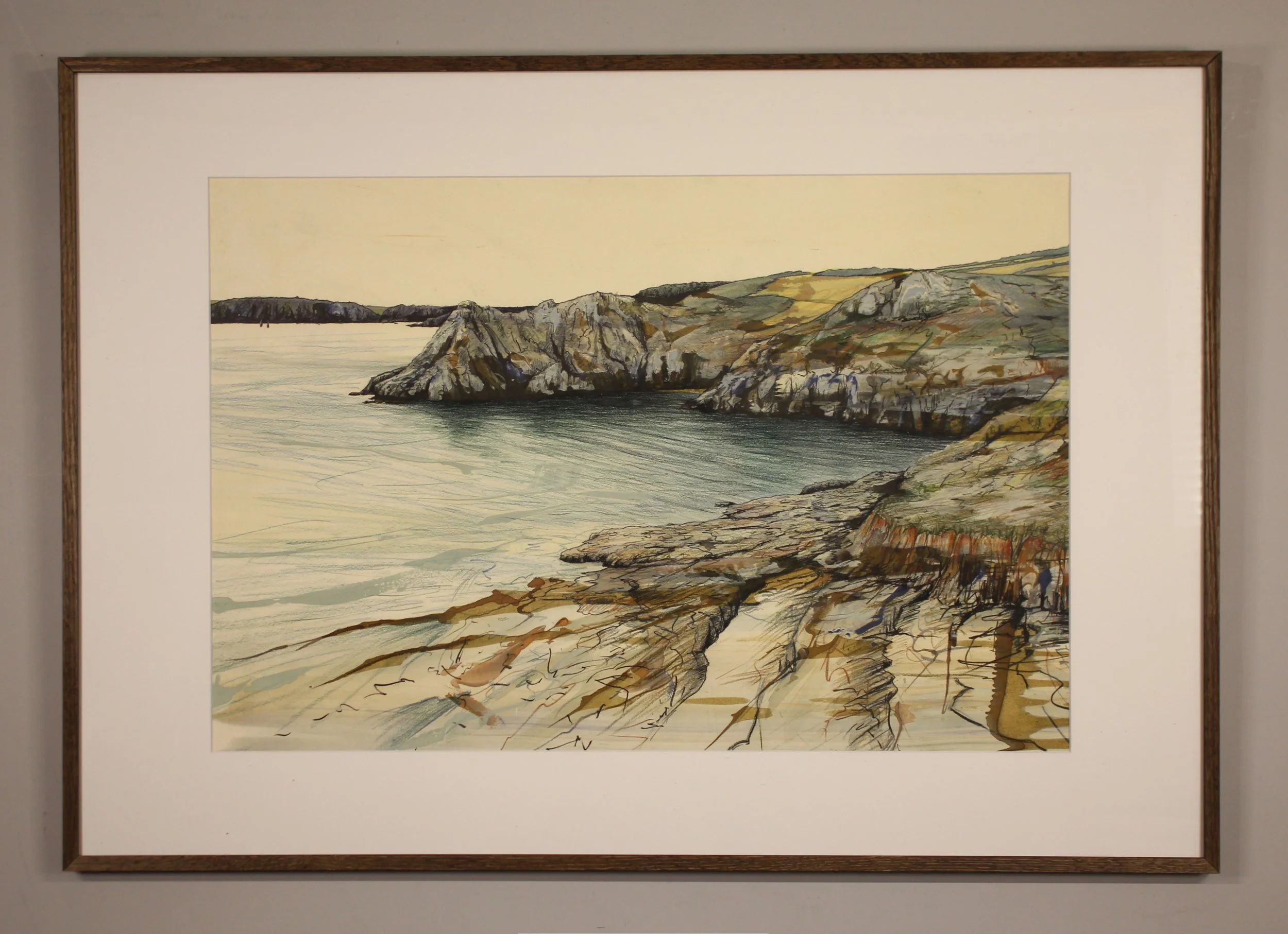 A sparse figurative drawing and painting of Gammon Head in Devon close to Salcombe. On the horizon a distant silhouetted headland leads to closer rocks and headlands with loose mark marking and expressive ink work. The rippled sea green blue of the w