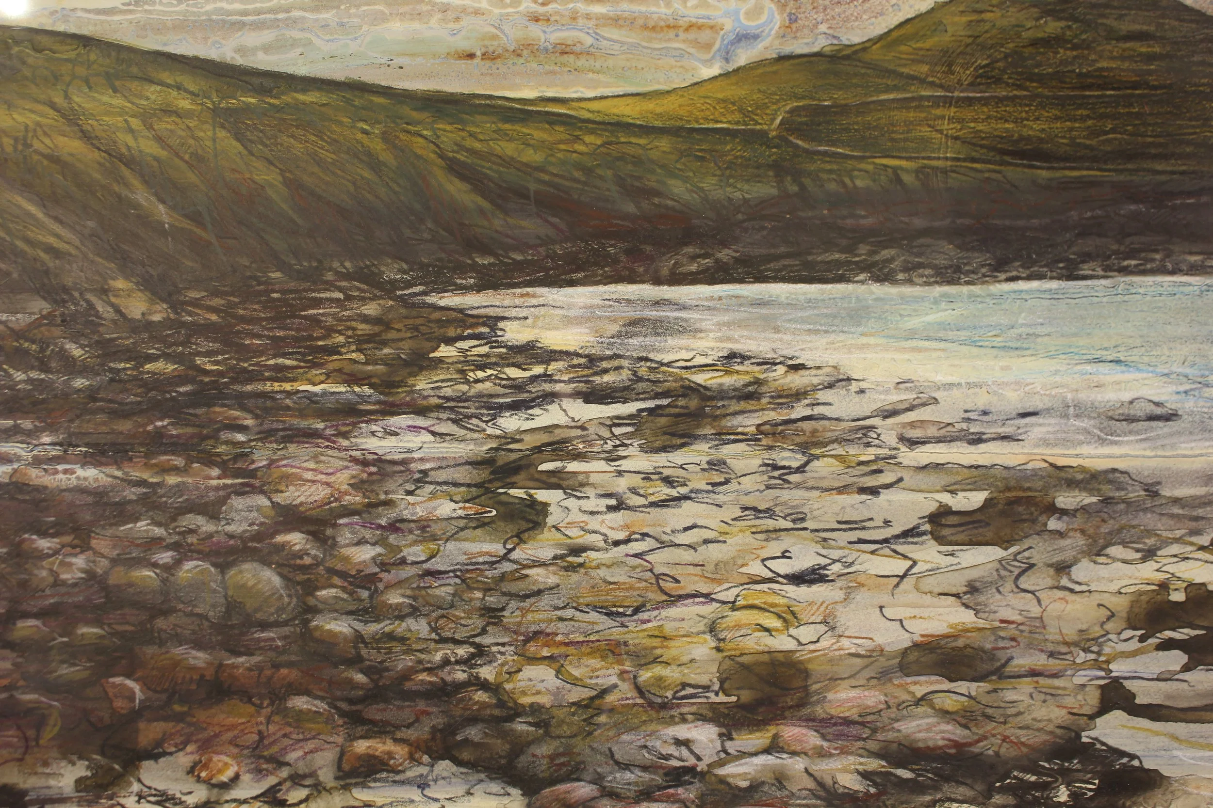 A colourful and moody drawing of a rocky beach with the Cape Cornwall headland on the horizon and a golden soft sunset behind. Expressive mark making ion the fore=ground ctreates the textures of the rocks on the sea shore.