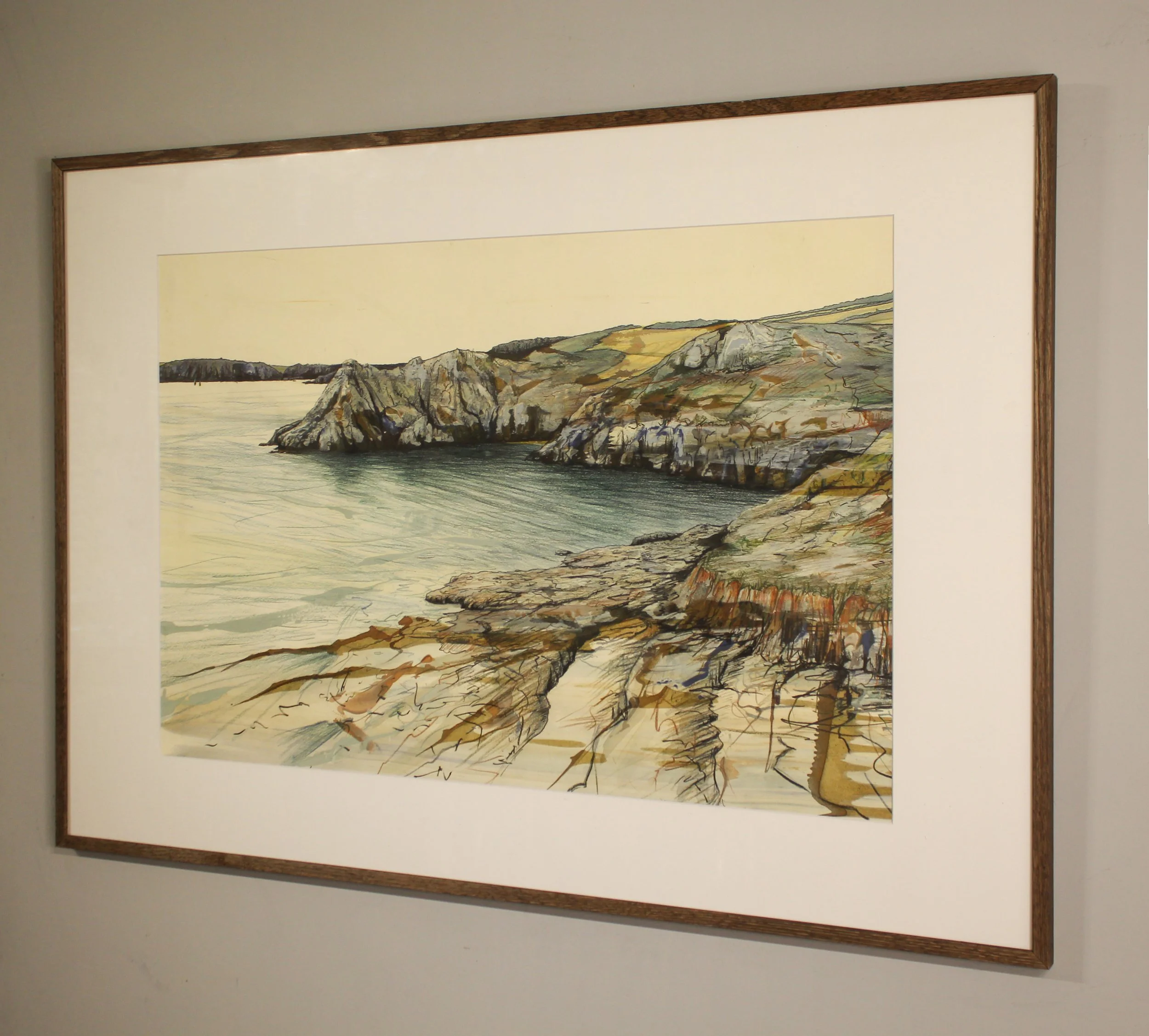A sparse figurative drawing and painting of Gammon Head in Devon close to Salcombe. On the horizon a distant silhouetted headland leads to closer rocks and headlands with loose mark marking and expressive ink work. The rippled sea green blue of the w