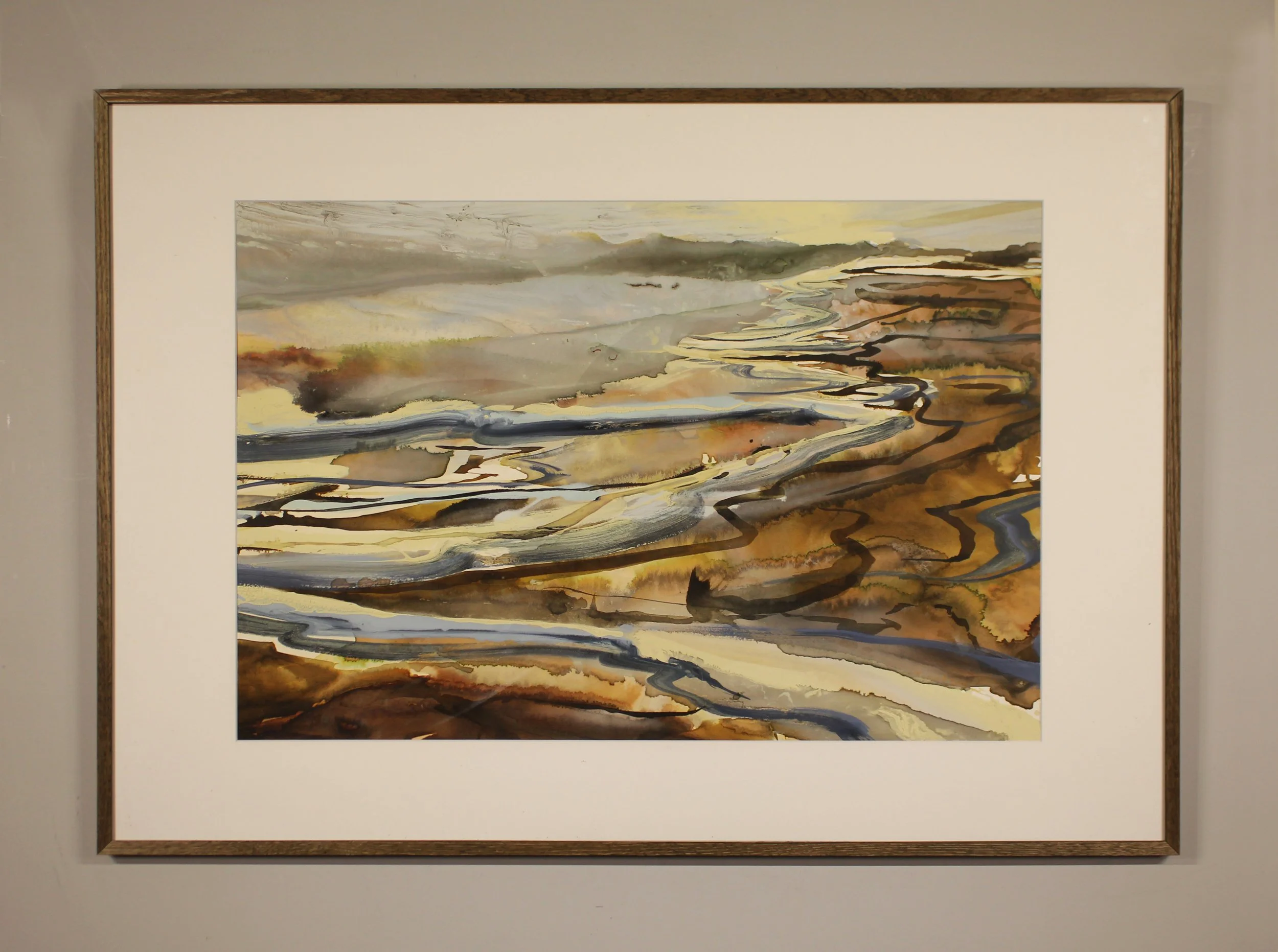 An abstracted ink painting that suggests waves depositing into to the beach. Paint and ink has been poured, seeped and dripped onto the surface in a calligraphic style with earth tones, frothy lemon whites and deeper slate grey tones.