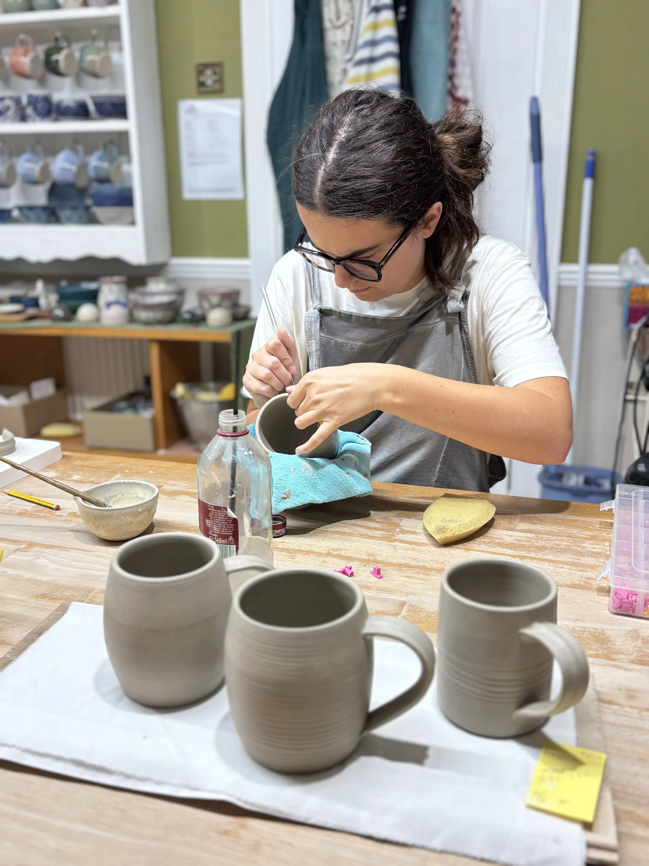   
 Lizzie has been trimming her mugs &  adding her handles! 
 