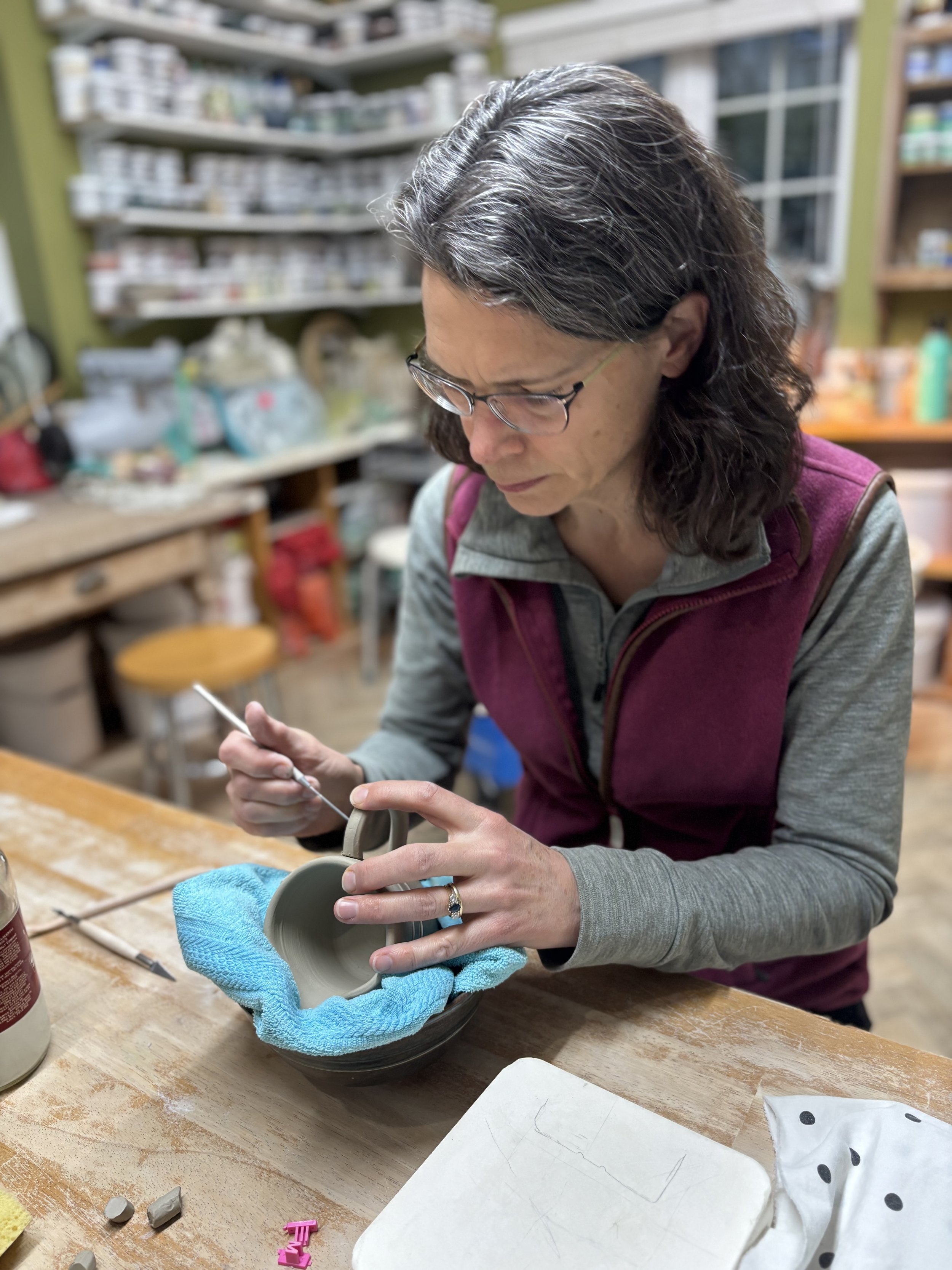   
 ... & Elly- attaching handles to their mugs!  
 