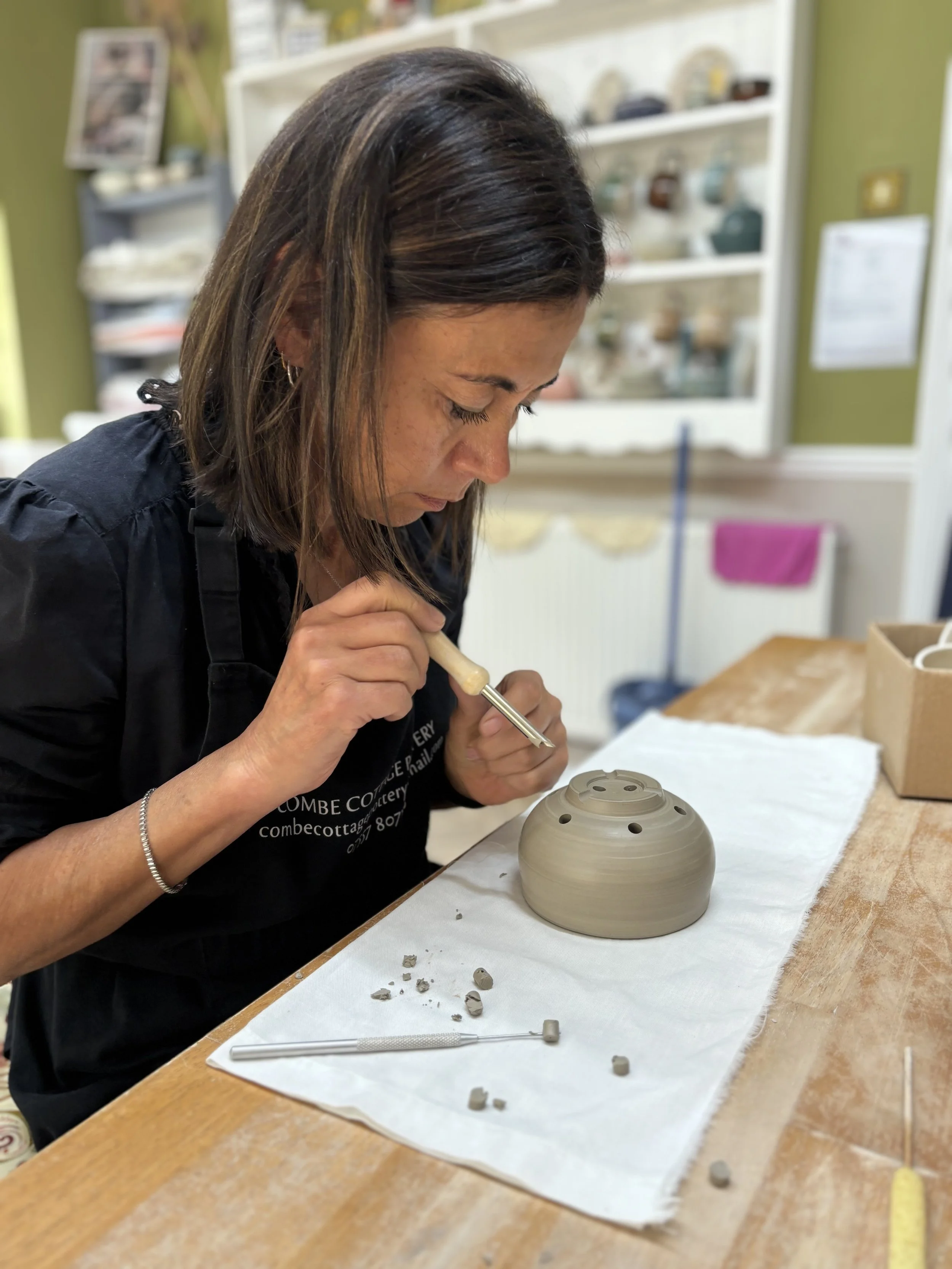 Amanda has been trimming her pieces and adding her holes to her berry bowl!