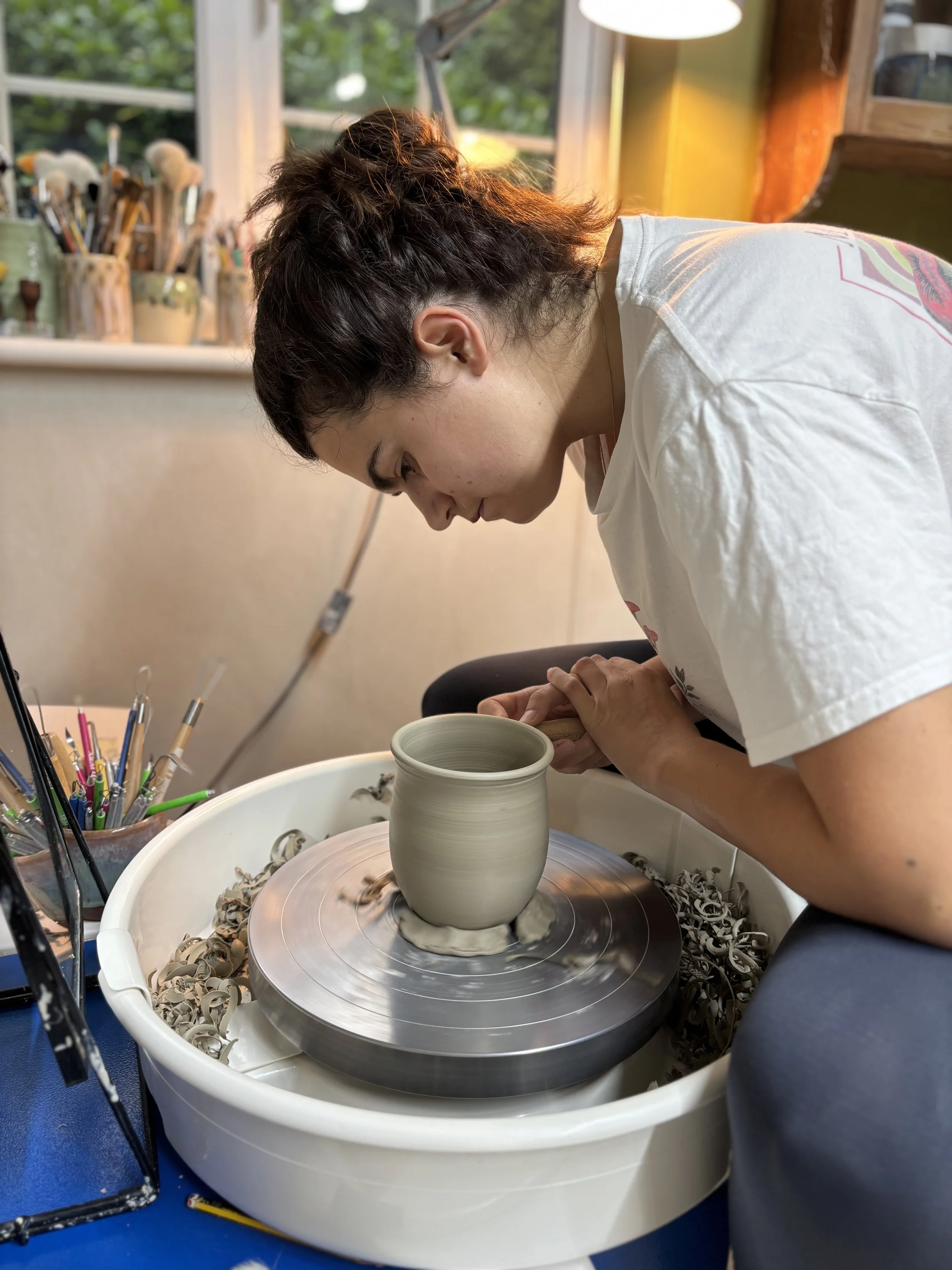   
 Lizzie has been trimming her latest mugs & throwing spoon rests! 
 